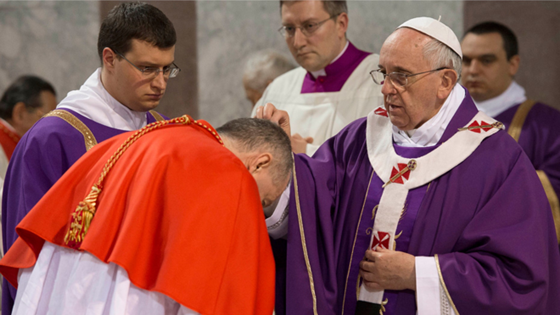 March 5, 2014: Pope Francis sprinkles with ashes a cardinal during the Ash Wednesday mass at the Santa Sabina Basilica in Rome.