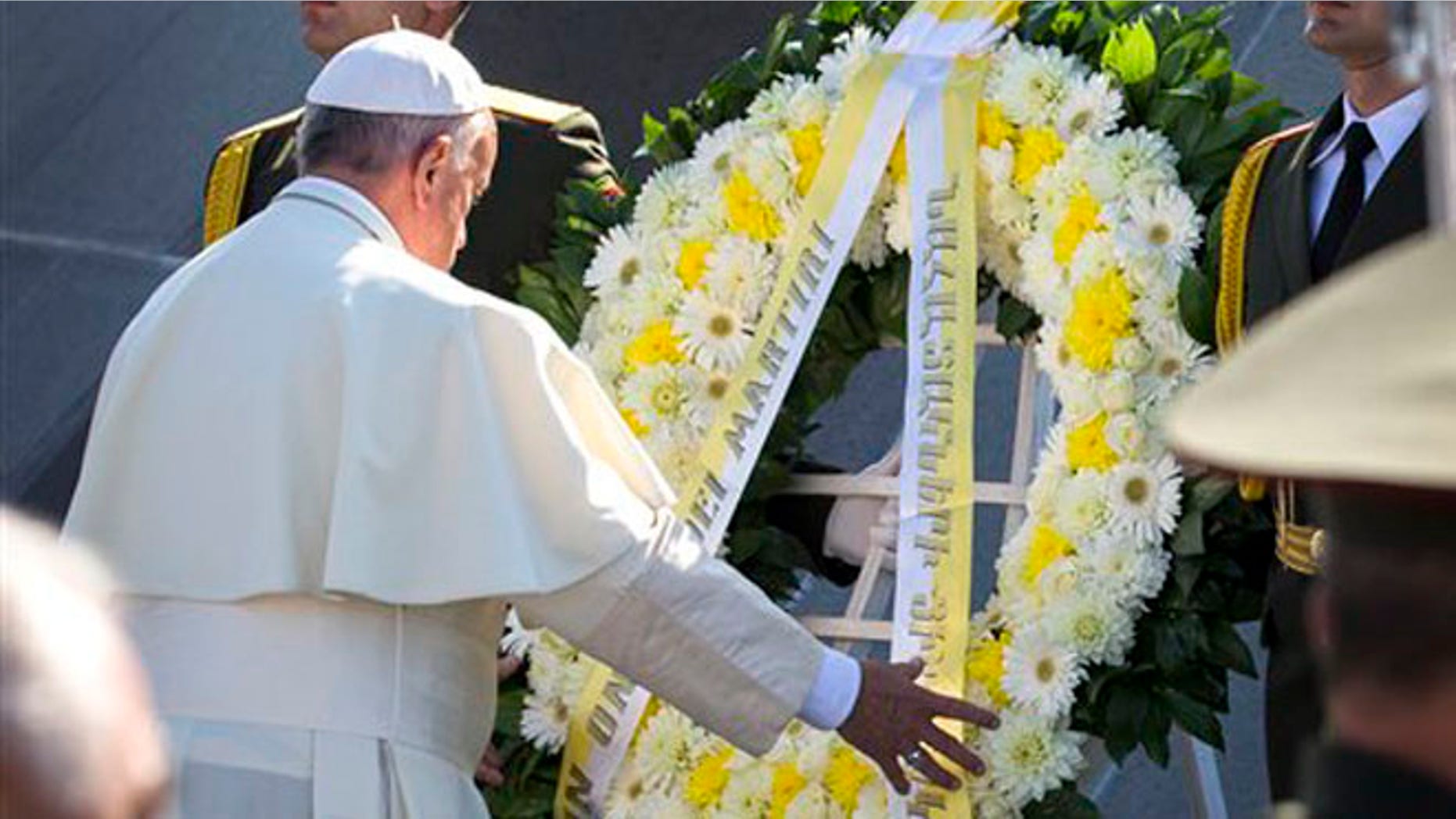 Pope Francis, left, attends a ceremony at a memorial to Armenians killed by the Ottoman Turks in Yerevan, Armenia, Saturday, June 25, 2016. Francis used another opportunity to pay respects to the victims of the slaughter when he visits Armenia's genocide memorial. (AP Photo/Alexander Zemlianichenko)