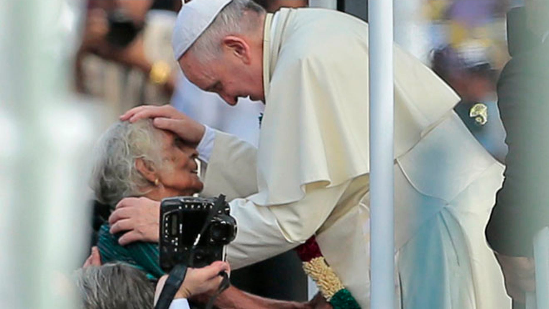 Jan. 14, 2015: Pope Francis reaches out to bless a Sri Lankan Catholic woman during his visit to the Church of Our Lady of Madhu in Madhu, Sri Lanka. (AP)