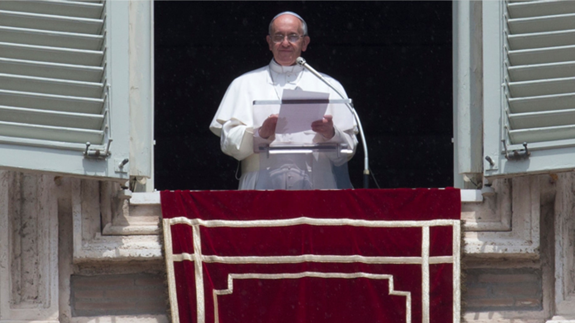 June 9, 2013: Pope Francis reads a message during the Angelus noon prayer he celebrated from the window of his studio overlooking St. Peter's square at the Vatican.