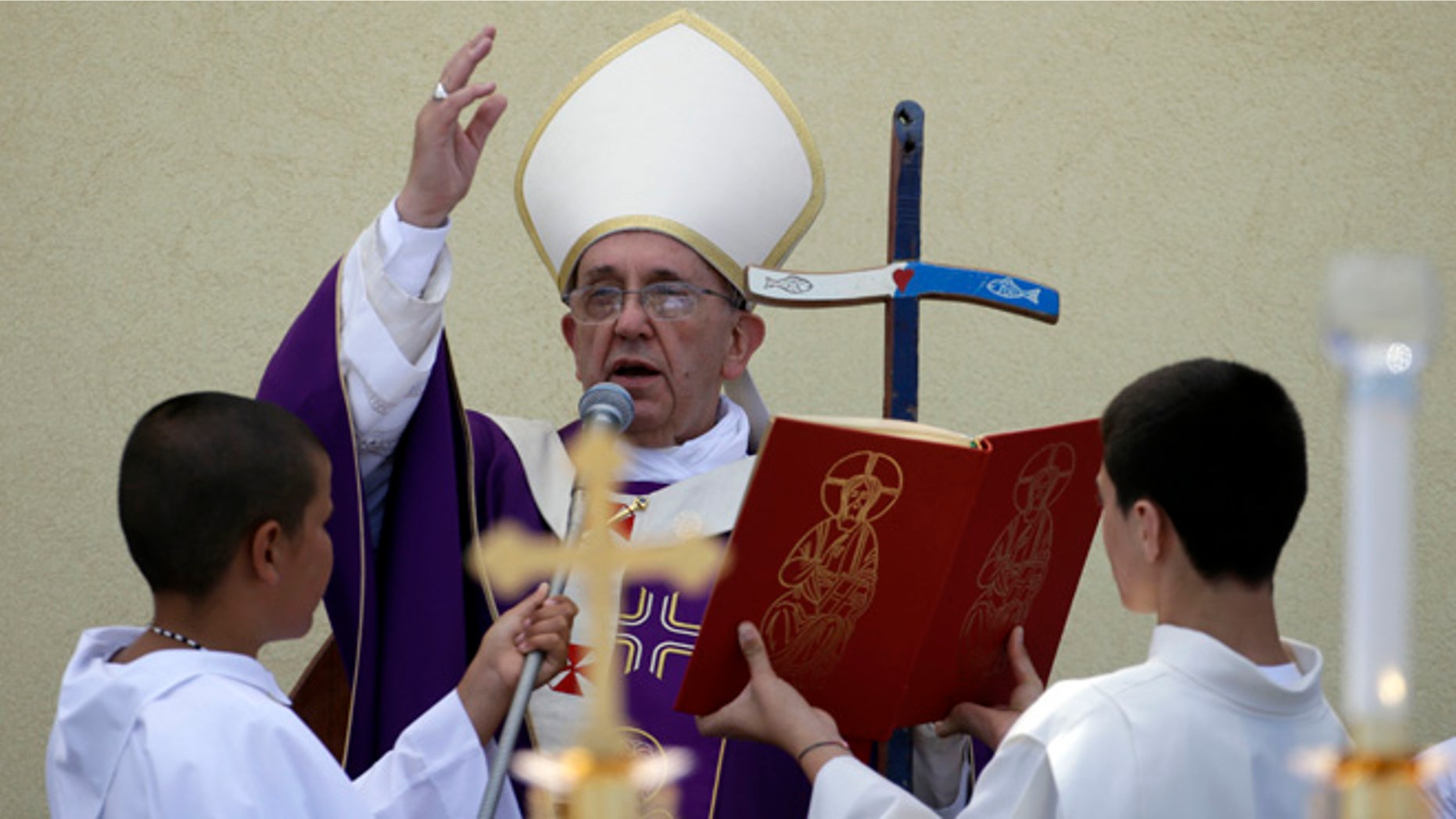 July 8, 2013: Pope Francis blesses faithful at the end of a Mass during his visit to the island of Lampedusa, southern Italy. Pope Francis traveled Monday to the tiny Sicilian island of Lampedusa to pray for migrants lost at sea, going to the farthest reaches of Italy to throw a wreath of flowers into the sea and celebrate Mass as yet another boatload of Eritrean migrants came ashore.