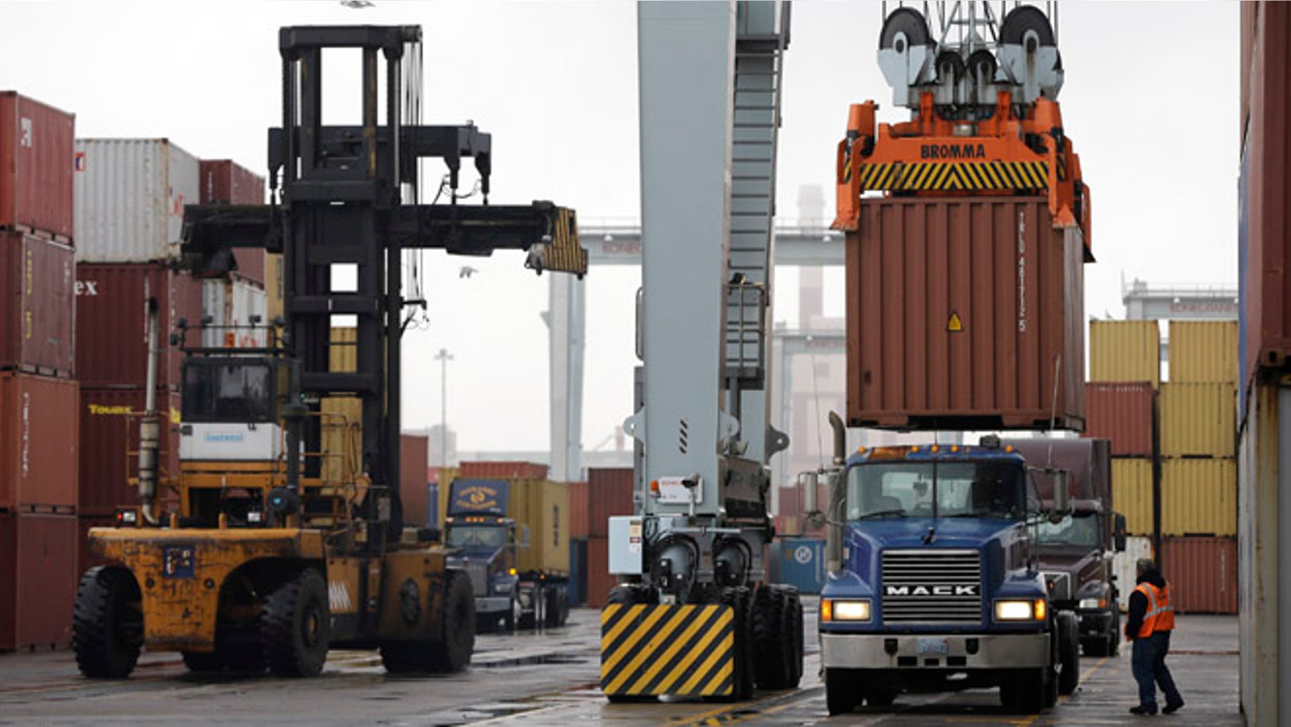Dec. 18, 2012: A truck driver watches as a freight container, right, is lowered at the Port of Boston.