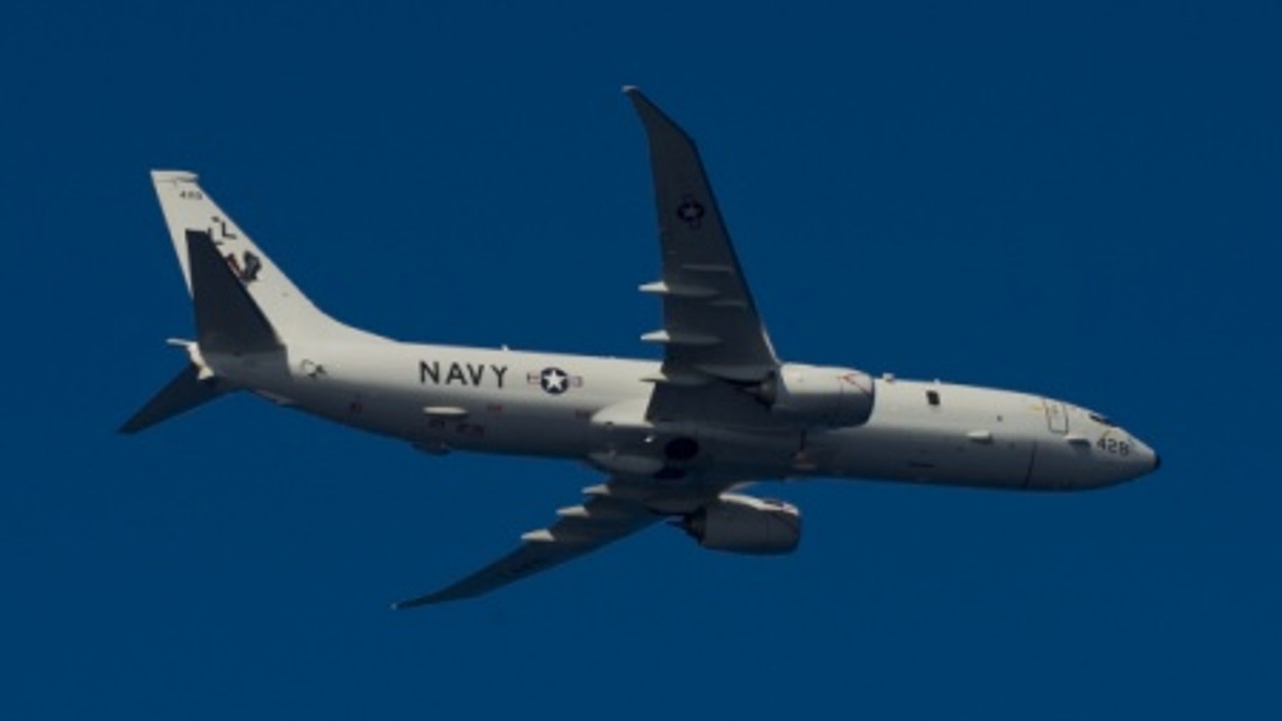 File photo - A P-8A Poseidon, assigned to Patrol Squadron (VP) 30, flies over the aircraft carrier USS Harry S. Truman (U.S. Navy photo by Mass Communication Specialist 2nd Class Mike DiMestico/Released).