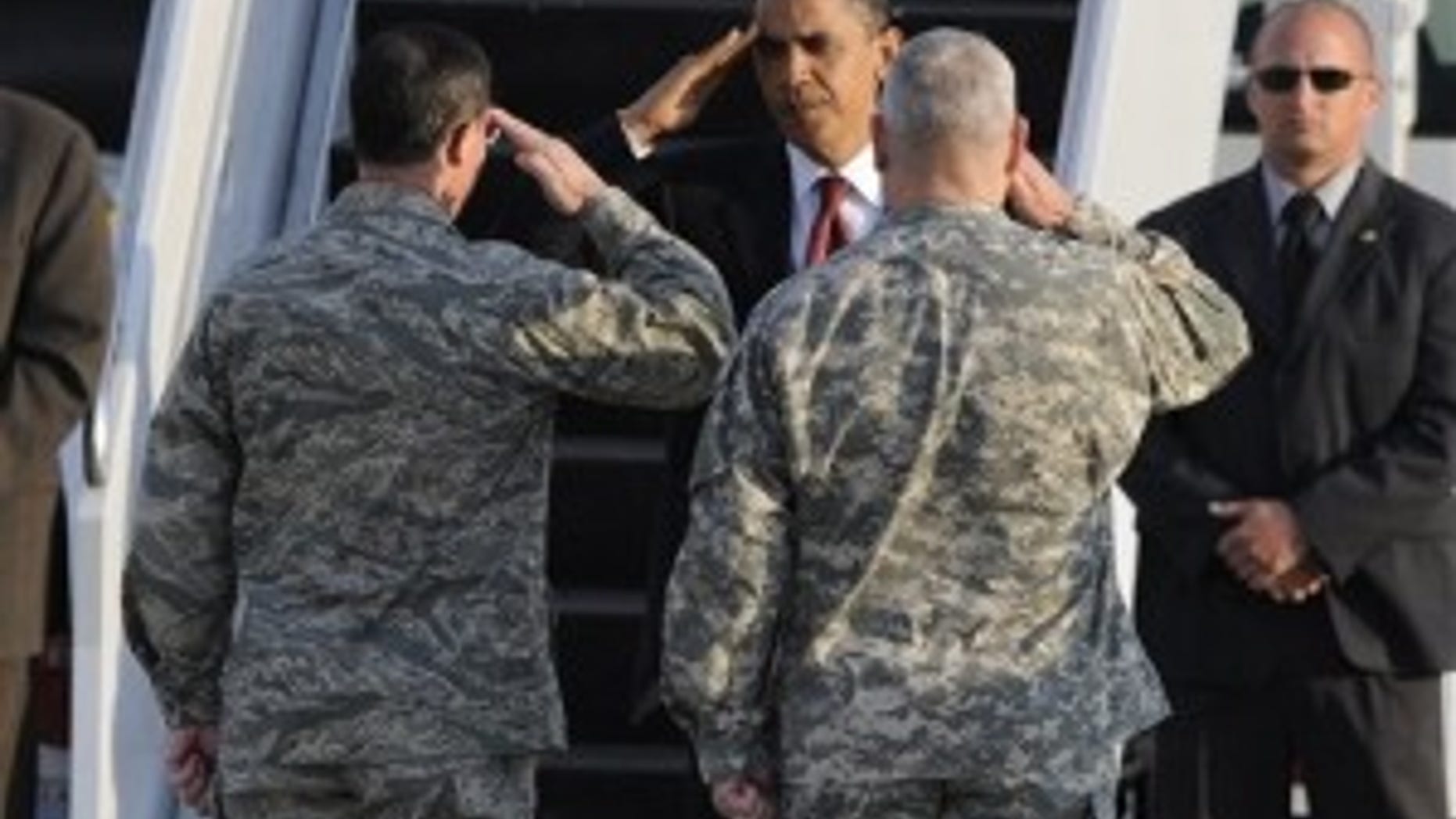President Barack Obama saluts to Army General Carter Ham, right, and Airforce General Mark Rogers as he leaves the US Airbase in Ramstein, Germany, Friday, June 5, 2009. Obama en route from Egypt to France visited Dresden, the former Nazi concentration camp Buchenwald and the US regional medical center in Landstuhl during his stopover in Germany. (AP Photo)