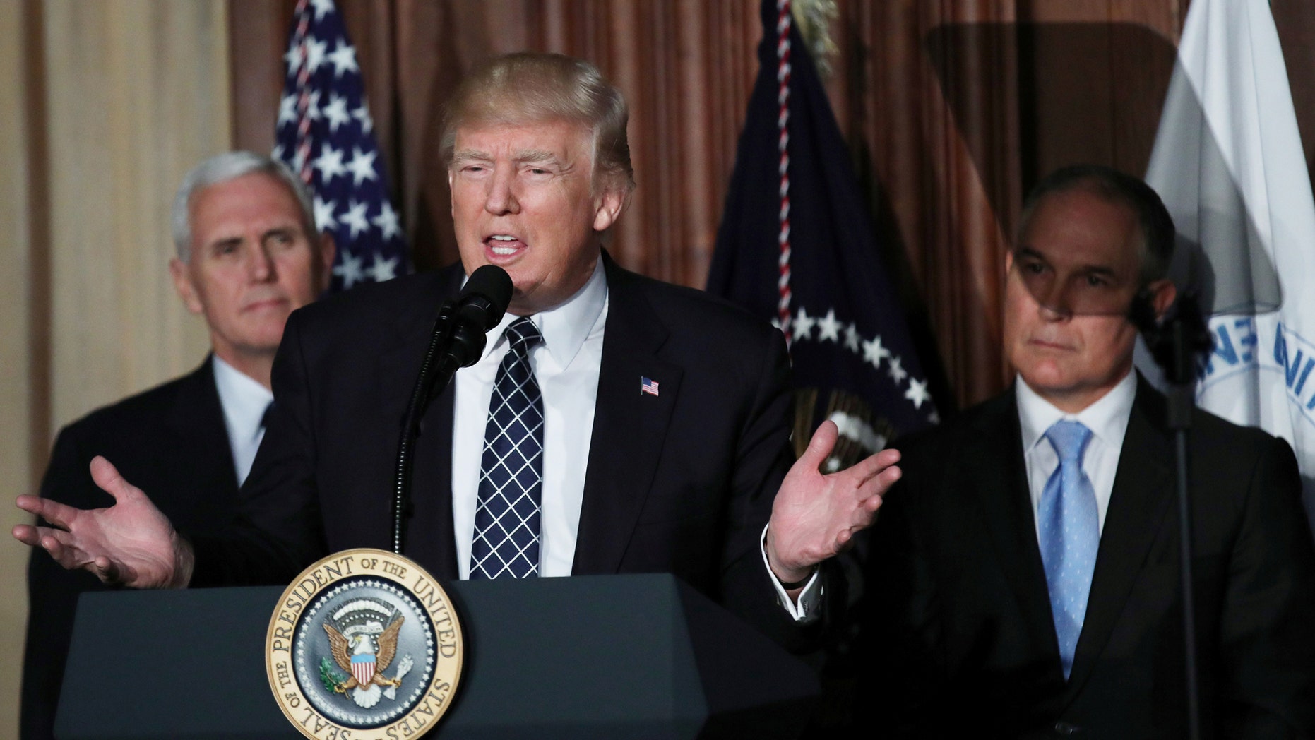 File photo: U.S. President Donald Trump speaks between Vice President Mike Pence (L) and EPA Administrator Scott Pruitt prior to signing an executive order on "energy independence," eliminating Obama-era climate change regulations, during an event at the Environmental Protection Agency (EPA) headquarters in Washington, U.S., March 28, 2017. (REUTERS/Carlos Barria)