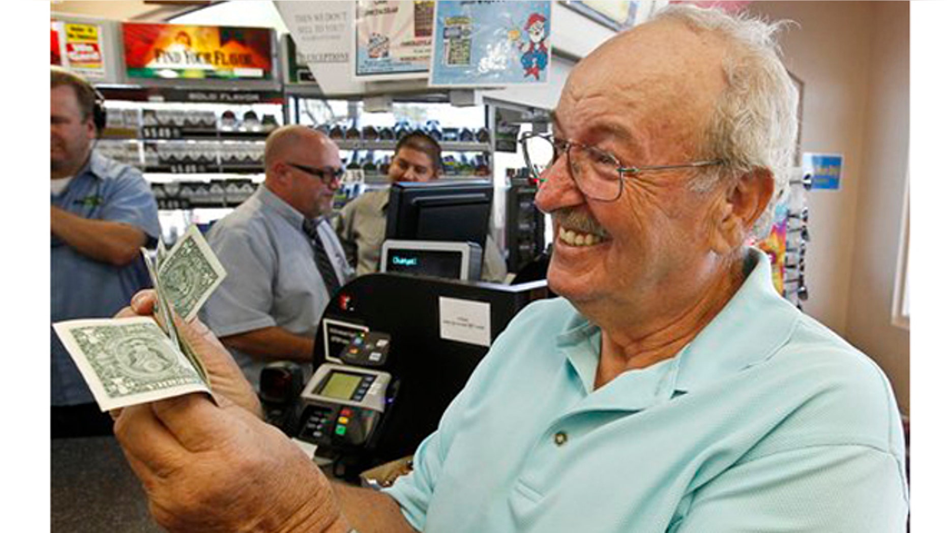 Wes Prinzen, of Fountain Hills, Ariz., smiles as he takes away his modest $4 winnings, at a 4 Sons Food Store where one of the winning tickets in the $579.9 million Powerball jackpot.