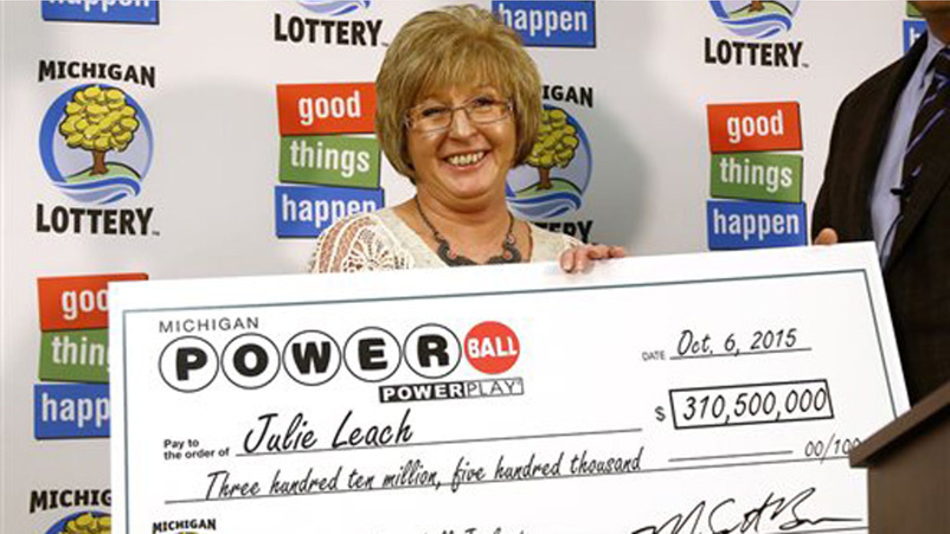 Oct 6, 2015: Powerball winner Julie Leach, of Three Rivers, Mich., holds a ceremonial check during a news conference at lottery headquarters in Lansing, Mich. Leach won $310.5 million in the Sept. 30 drawing.
