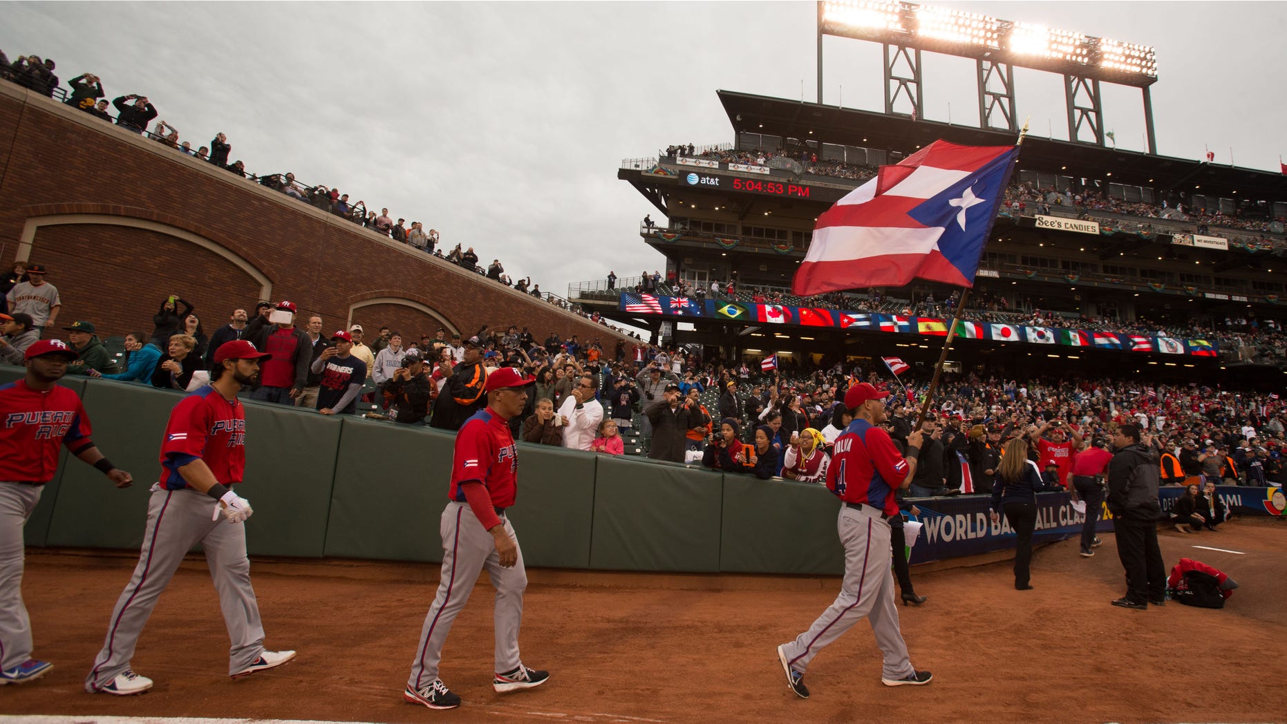 SAN FRANCISCO, CA - MARCH 19: Yadier Molina #4 of Team Puerto Rico leads his team onto the field carrying the Puerto Rican flag before the 2013 World Baseball Classic Championship Game against Team Dominican Republic on Tuesday, March 19, 2013 at AT&T Park in San Francisco, California. (Photo by Jed Jacobsohn/WBCI/MLB Photos via Getty Images) *** Local Caption *** Angel Pagan;Edwin Rodriguez;Yadier Molina