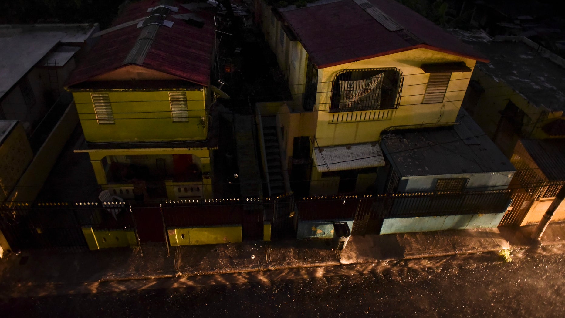 Vehicle lights illuminate a street after a massive blackout, in San Juan, Puerto Rico, Thursday, Sept. 22, 2016.