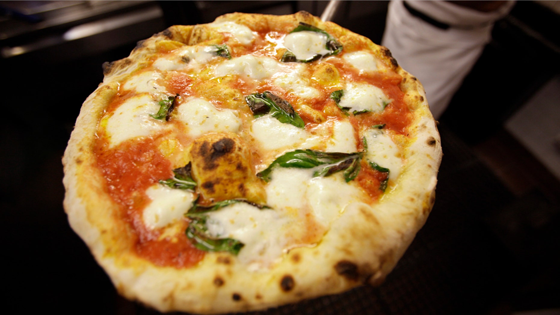 Jan. 27: Tony Gemignani removes a pizza margherita from an oven at Tony's Pizza Napoletana in San Francisco. Super Bowl Sunday is coming and pie-makers across the country are bracing for a pizza reaction. (AP Photo/Eric Risberg)