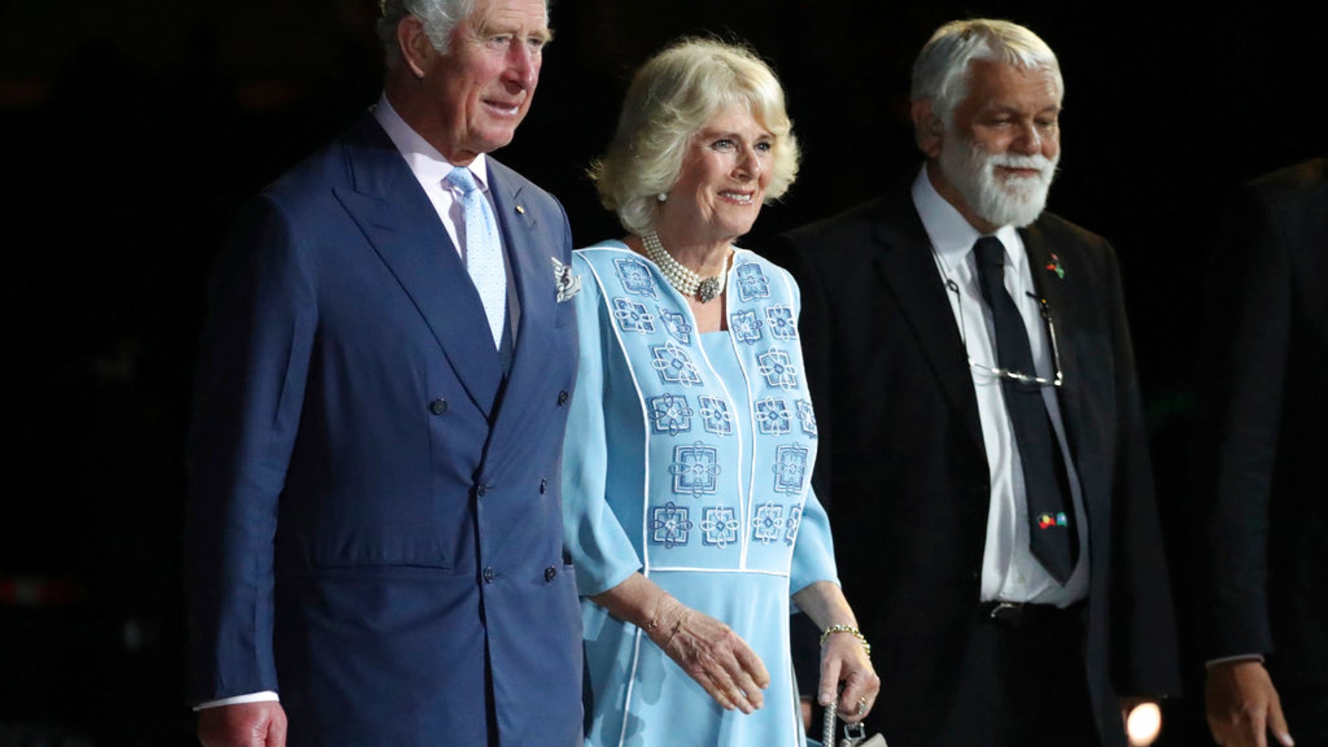 Prince Charles, left and Camilla, Duchess of Cornwall, center, arrive with Aboriginal Elder Ted Williams during the opening ceremony for the 2018 Commonwealth Games at Carrara Stadium on the Gold Coast, Australia, Wednesday, April 4, 2018. (AP Photo/Dita Alangkara)