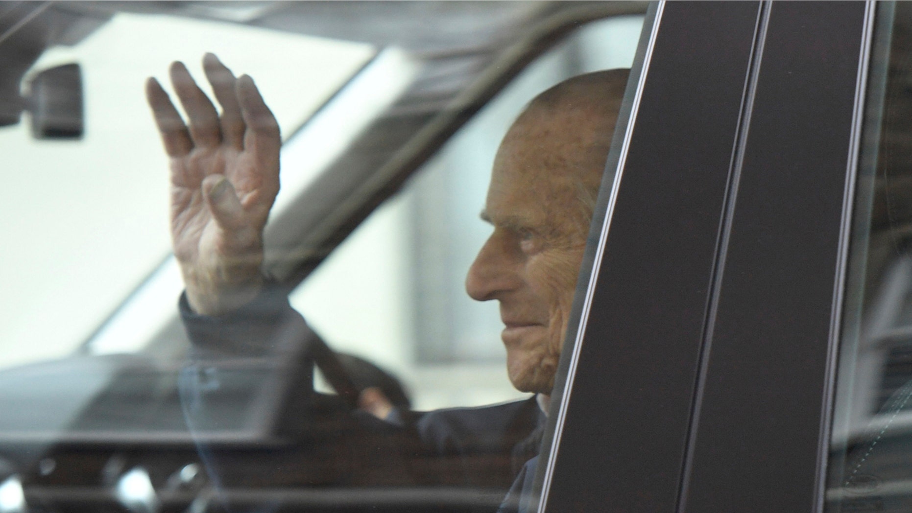 Britain's Prince Philip waves as he leaves the King Edward VII Hospital, after recovering from a planned surgery last Wednesday, in London, Friday, April 13, 2018. (Victoria Jones/PA via AP)