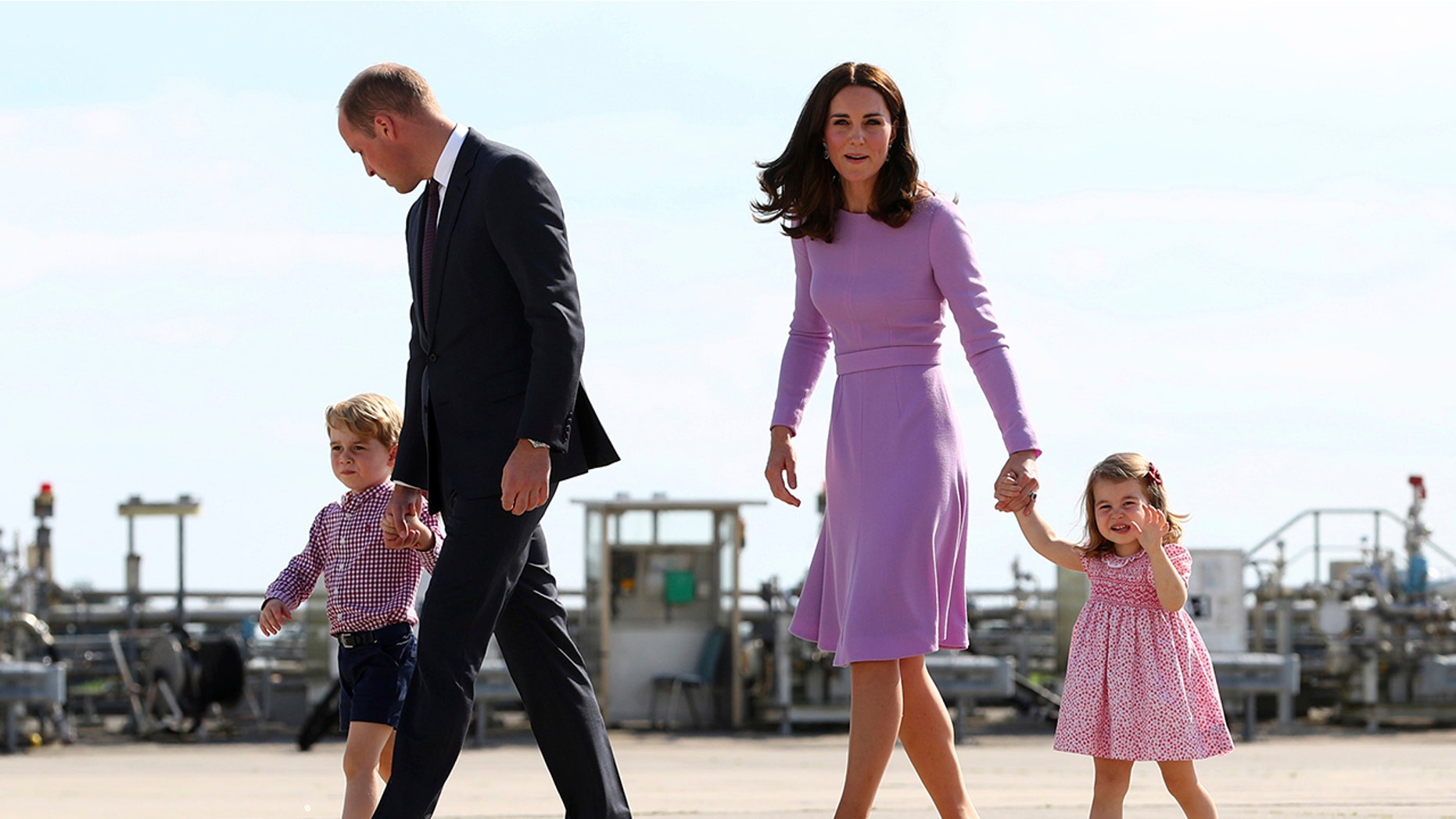 In this Friday, July 21, 2017 file photo Britain's Prince William, second left, and his wife Kate, the Duchess of Cambridge, second right, and their children, Prince George, left, and Princess Charlotte, right are on their way to board a plane in Hamburg, Germany