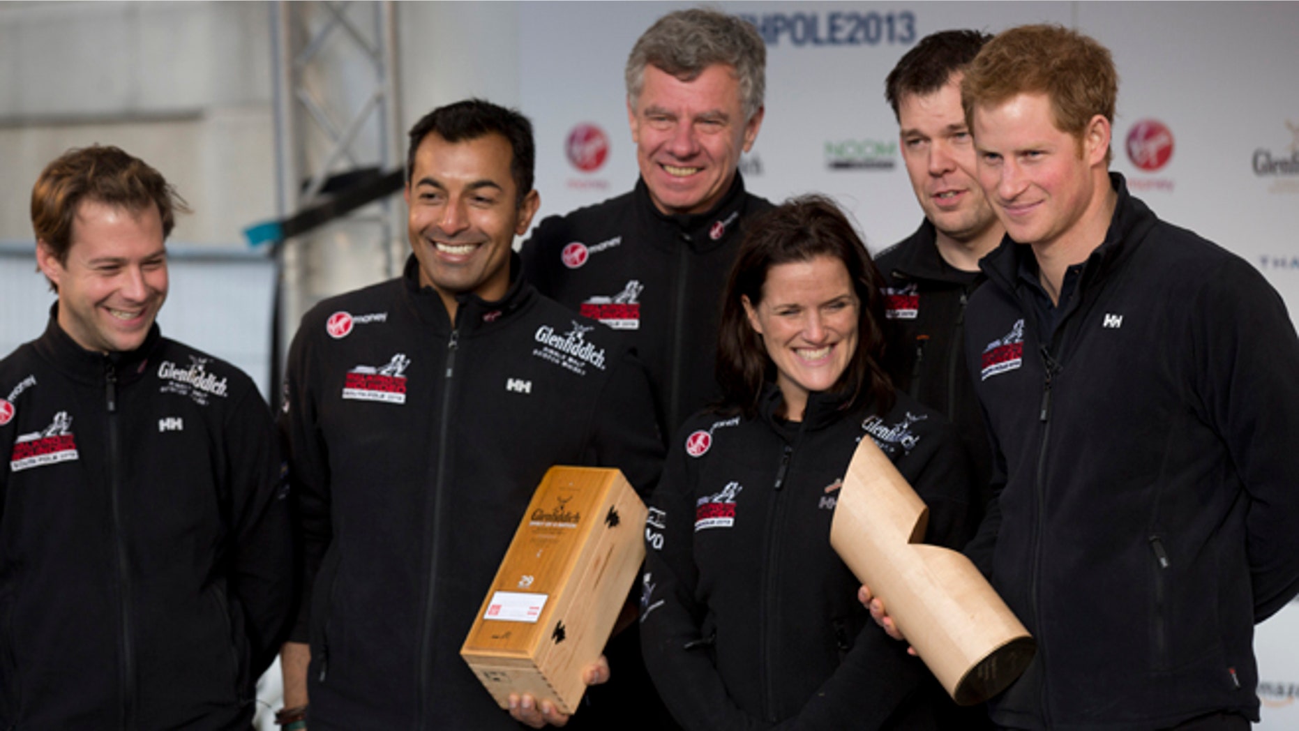 Nov. 14, 2013: Britain's Prince Harry, right, poses for a group photograph on stage with his teammates, from left, single leg amputee Guy Disney, single leg amputee Ibrar Ali MC, team mentor Richard Eyre, single leg amputee Kate Philp and double leg amputee Duncan Slater during the "Walking With The Wounded South Pole Allied Challenge" departure event in Trafalgar Square, London.