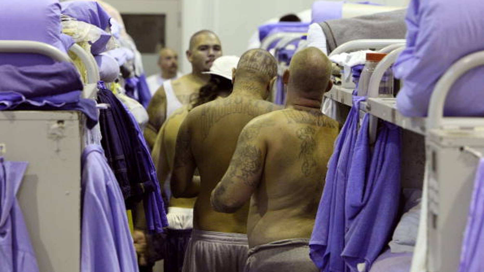 IONE, CA - AUGUST 28: Inmates at the Mule Creek State Prison crowd between bunk beds in a gymnasium that was modified to house prisoners August 28, 2007 in Ione, California. A panel of three federal judges is looking to put a cap on the California State Prison population after class action lawsuits were filed on behalf of inmates who complained of being forced to live in classrooms, gymnasiums and other non-traditional prison housing. California prisons house nearly 173,000 inmates with over 17,000 of them in non-traditional housing. The Mule Creek State Prison has had to modify several facilities to make room for an increasing number of inmates. (Photo by Justin Sullivan/Getty Images)