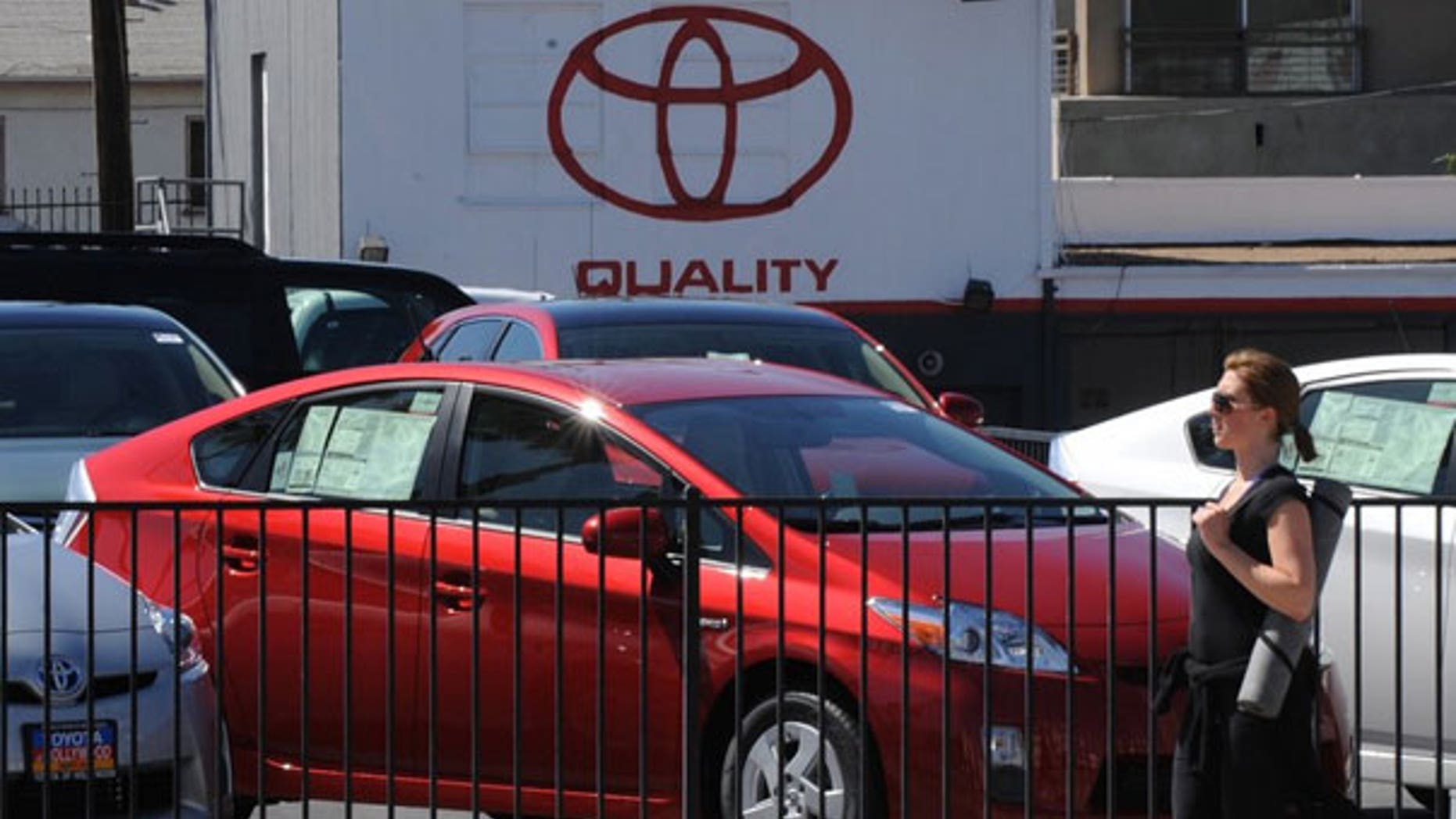 April 6: A woman walks past Toyota Prius cars for sale at a Toyota dealer in Hollywood. (AFP)