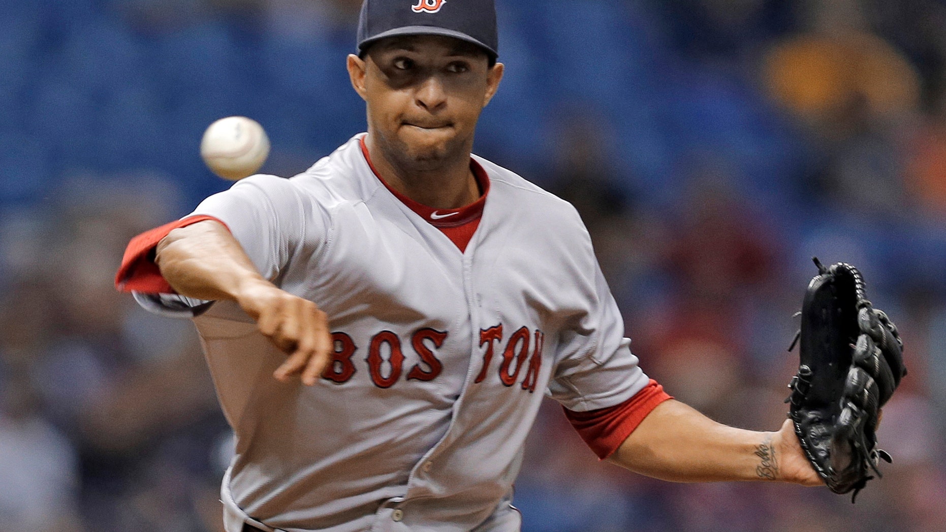 Boston Red Sox reliever Anthony Varvaro tries to pick off a Tampa Bay Ray baserunner during a game in St. Petersburg.