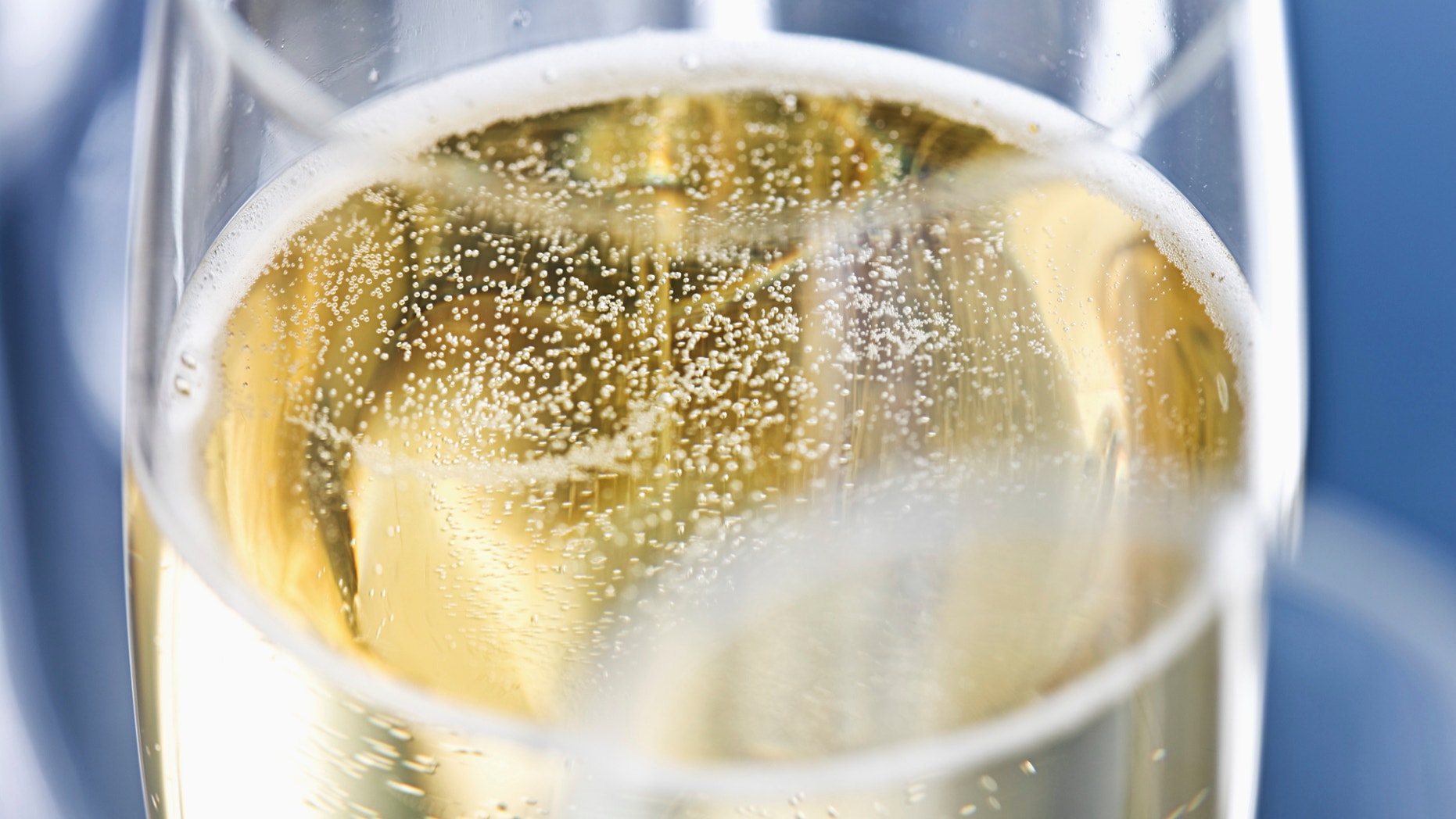 Close up of champagne bubbling in a champagne flute.