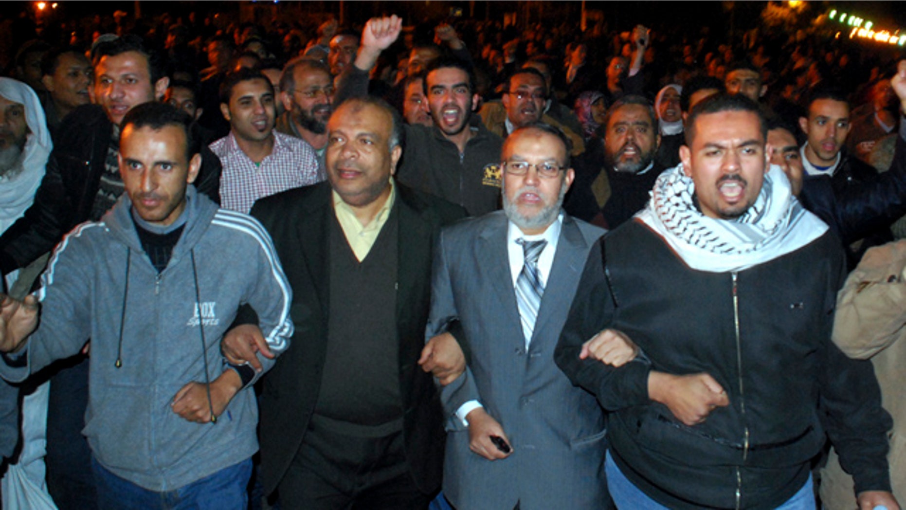 Jan. 30, 2011: Egyptian Brotherhood seniors Essam el-Erian, centre right, and Saad el-Katatni, centre left, take part in a protest in Cairo, Egypt.