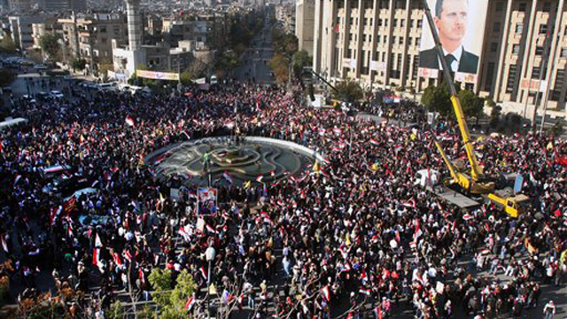 Pro-Syrian regime protesters gather during a protest against sanctions, in Damascus, Syria, on Friday Dec. 2, 2011.