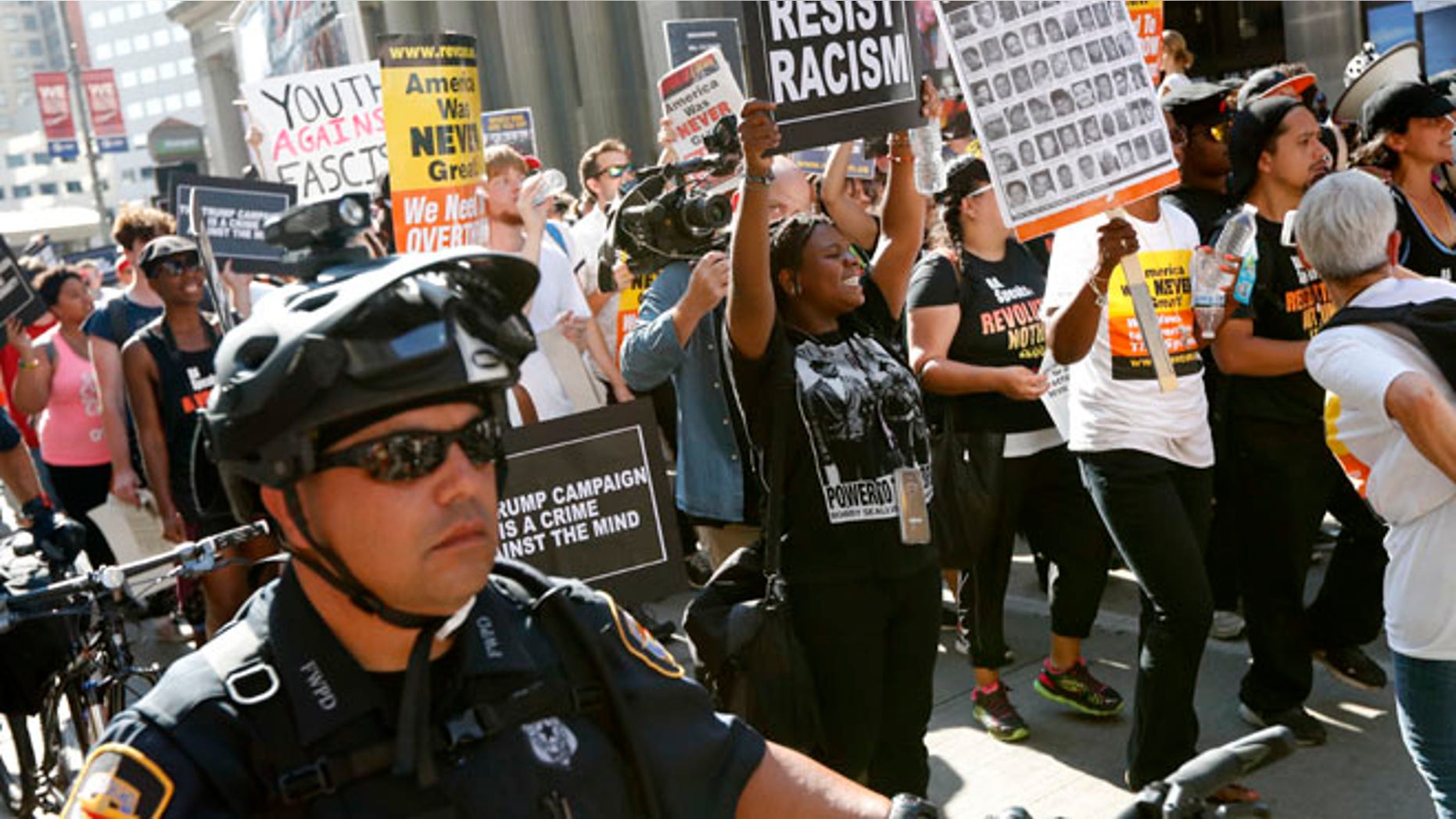 Protesters march in downtown Cleveland, on Tuesday, July 19, 2016, during the second day of the Republican convention. (AP Photo/John Minchillo)