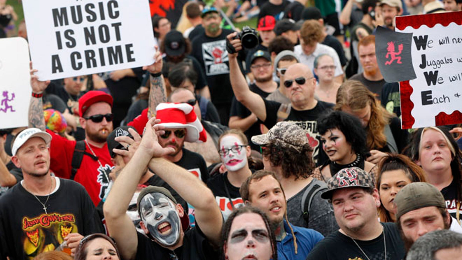 Juggalos, as supporters of the rap group Insane Clown Posse are known, gather in front of the Lincoln Memorial in Washington during a rally, Saturday, Sept. 16, 2017, to protest and demand that the FBI rescind its classification of the juggalos as "loosely organized hybrid gang." (AP Photo/Pablo Martinez Monsivais)