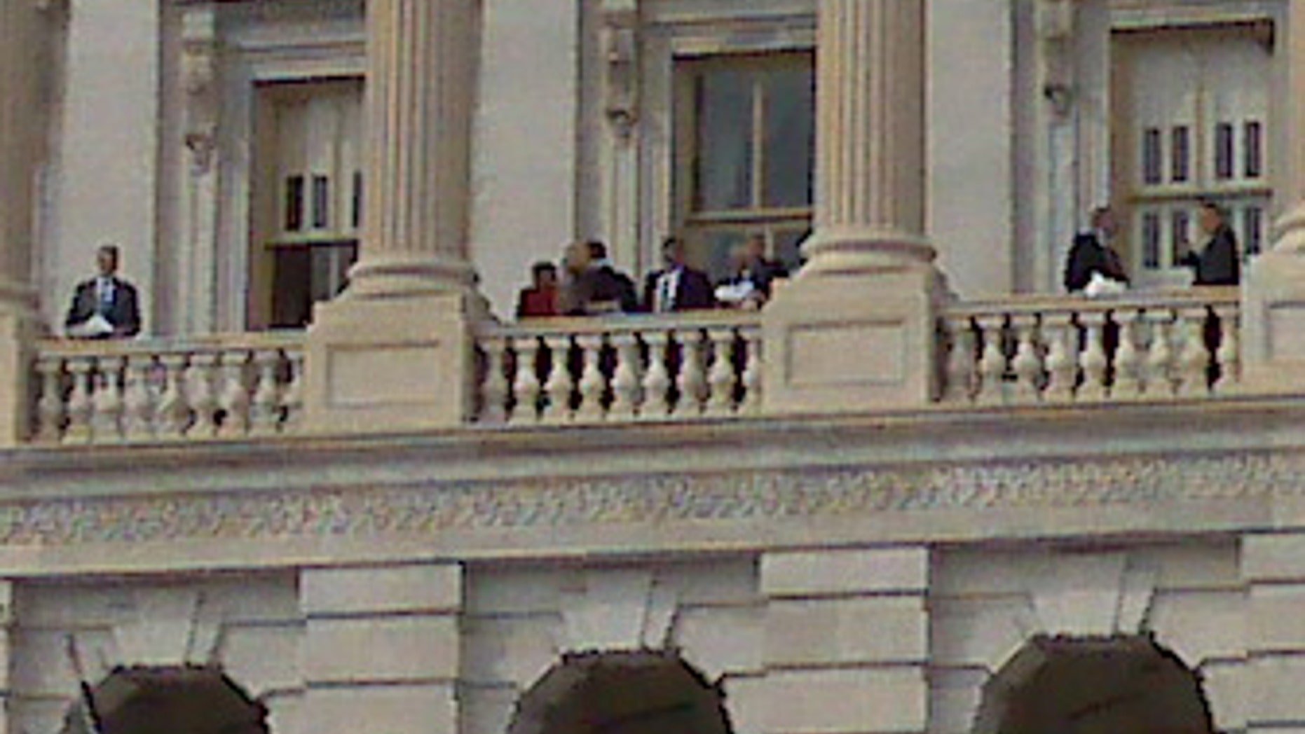 Sunday: Lawmakers look out from the Capitol Balcony before voting on a health insurance overhaul. (AP)