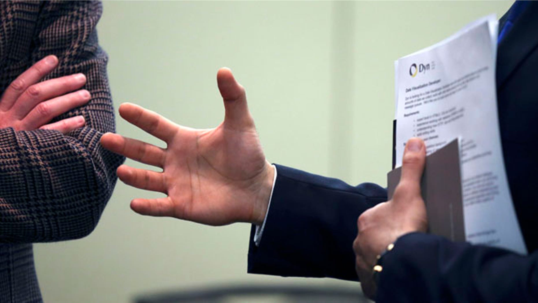 Feb. 25, 2013: A job seeker gestures while speaking to a company representative during a job fair in Boston.