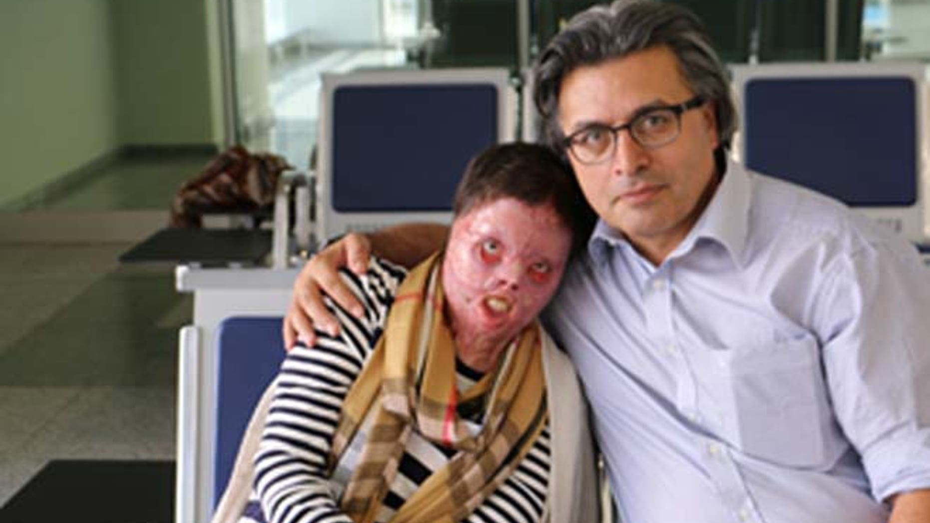 Yasmin, who set herself on fire to avoid a brutal attack by ISIS, is shown with Dr. Jan Kizihan.
