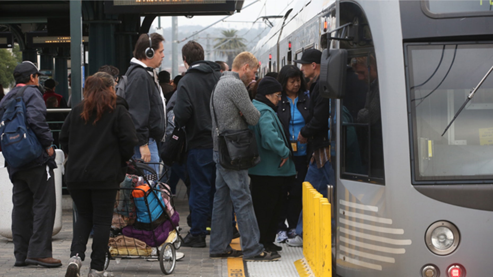 March 7, 2014: Pedestrians board a train at Union Station in Los Angeles. Americans are boarding public buses, trains and subways in greater numbers than any time since the suburbs began to boom. Nearly 10.7 billion trips in 2013, to be precise, the highest number since 1956.
