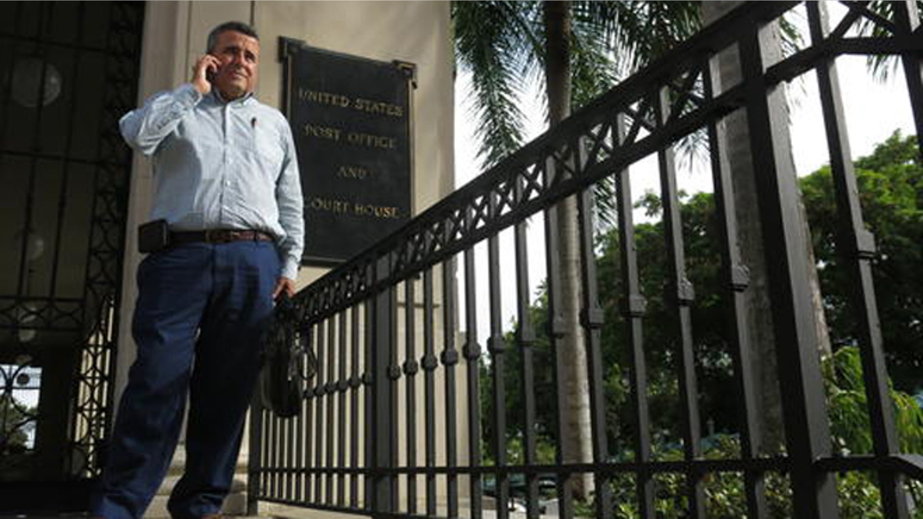 Attorney Santiago Mari talks to a client in front of a federal courthouse in San Juan, Puerto Rico.