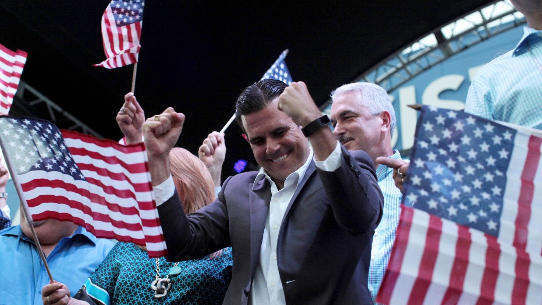 FILE -- Puerto Rico Governor Ricardo Rosello (C) celebrates after the economically struggling U.S. island territory voted overwhelmingly on Sunday in favour of becoming the 51st state, in San Juan, Puerto Rico June 11, 2017.