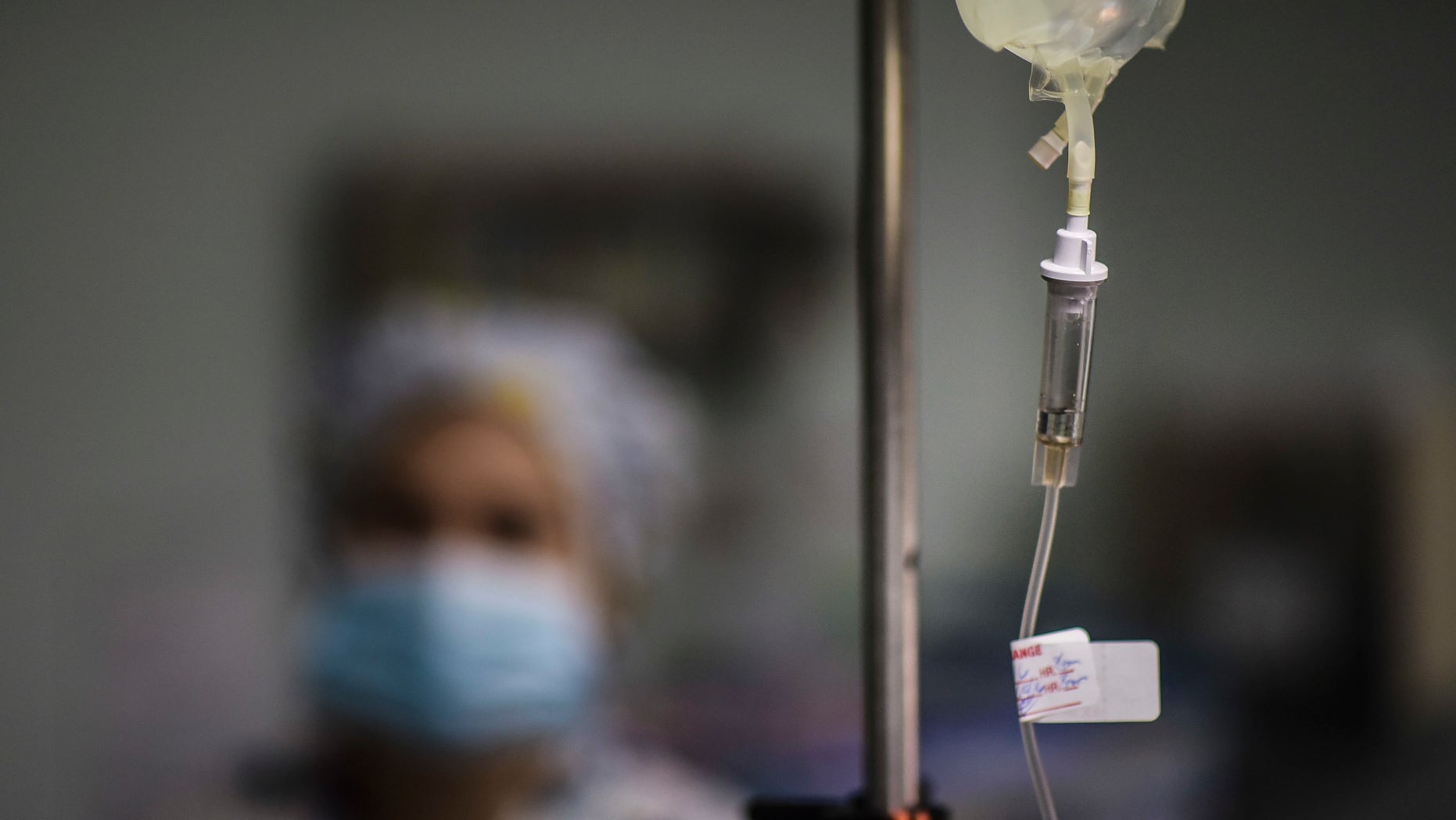 In this Oct. 7, 2016 photo, a nurse provides assistance to the surgical staff at the Dr. Isaac Gonzalez MartÃnez Oncological Hospital in San Juan, Puerto Rico, where services are offered to cancer patients with limited financial resources. Like many doctors, nurses are also moving to the United States in search of better wages. (AP Photo/Carlos Giusti)