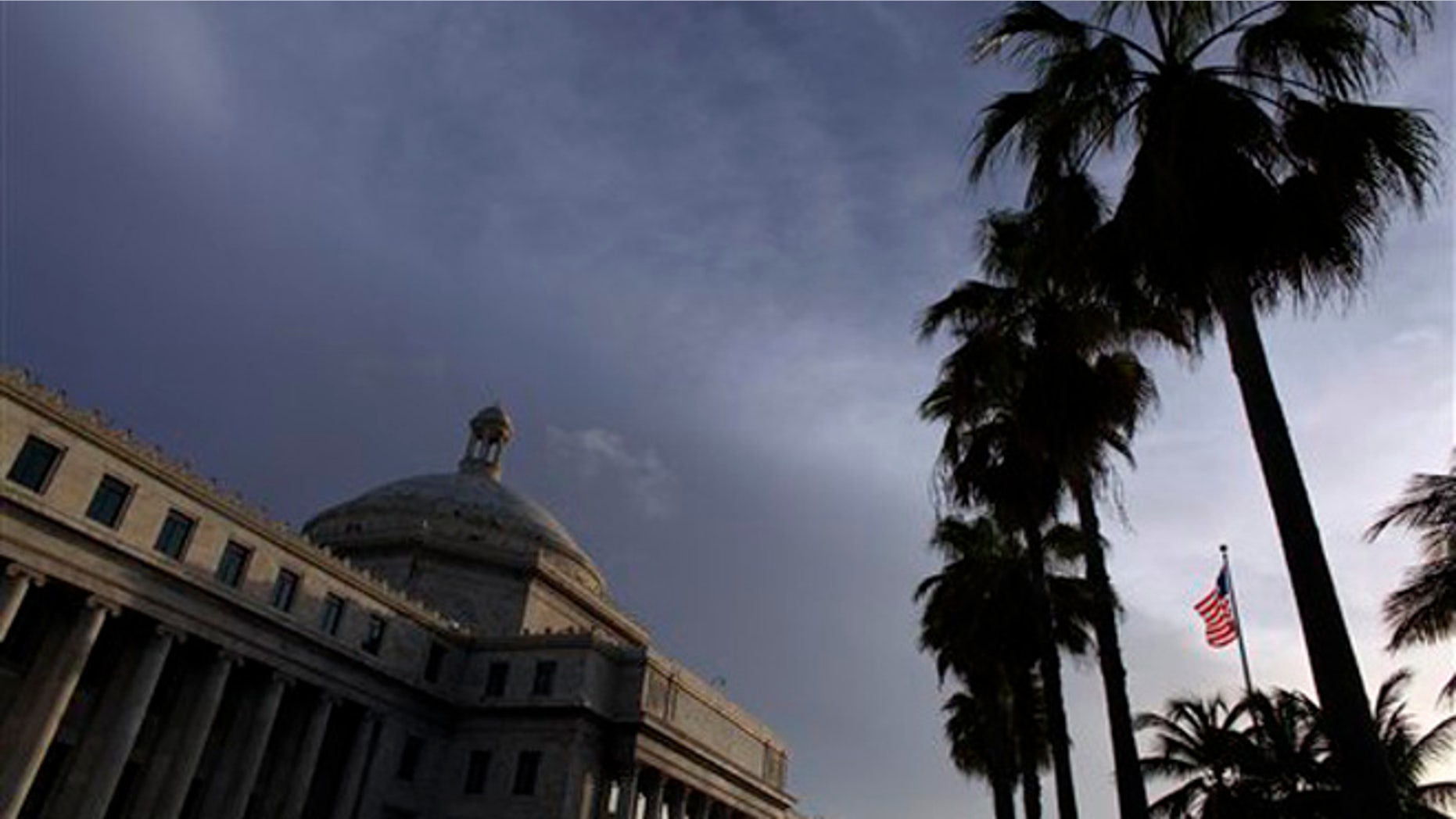 FILE - In this July 29, 2015 file photo, the U.S. flag flies in front of Puerto Ricoâs Capitol in San Juan, Puerto Rico. Plans to create a powerful fiscal control board to help stabilize the U.S. territory's finances and appease bondholders amid an economic crisis have been derailed. On Thursday, Nov. 12, 2015, legislators approved the measure but only after making amendments that strip the board of most of its powers. The Senate will review the amended bill again before it is presented to the islandâs governor. (AP Photo/Ricardo Arduengo, File)