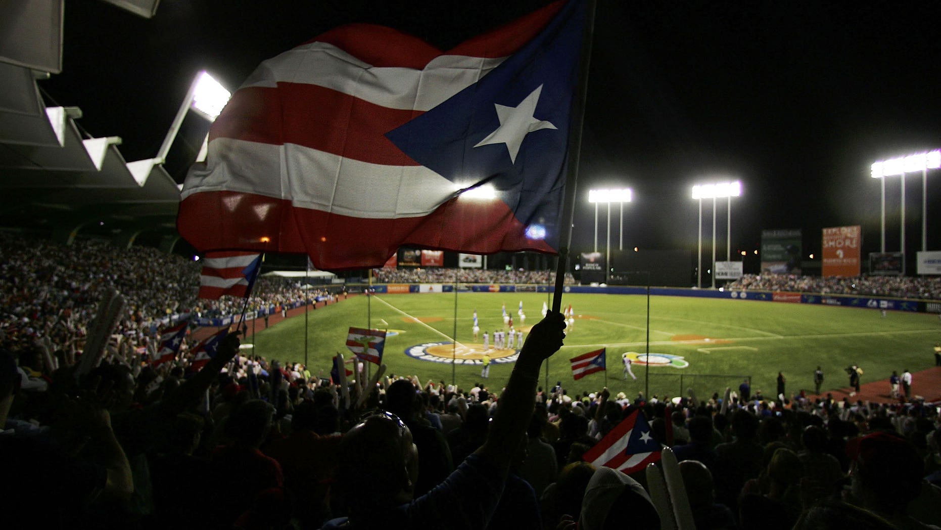 A fan waves the Puerto Rican flag before a World Baseball Classic game. (Photo by Al Bello/Getty Images)