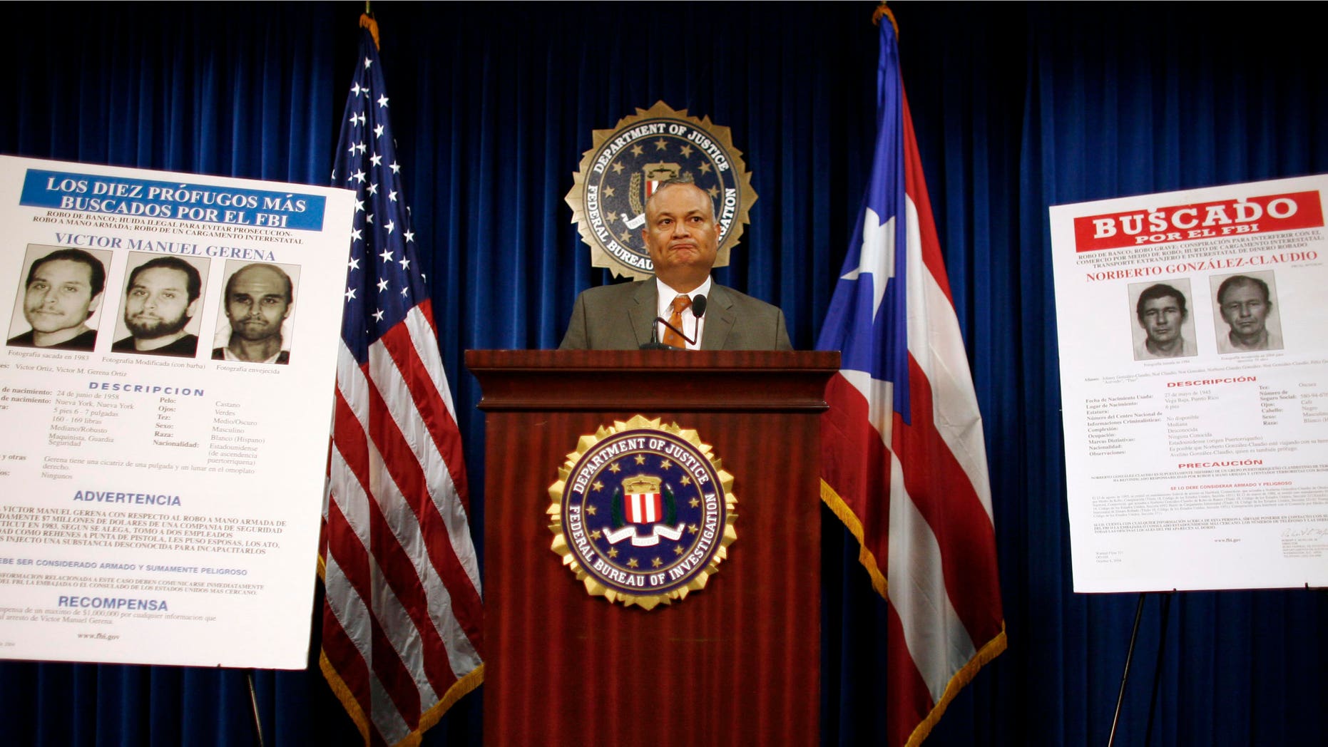 Puerto Rico's top FBI official Luis Fraticelli stands next to a wanted poster showing Norberto Gonzalez Claudio, right, at a news conference after Claudio's arrest, at FBI headquarters in San Juan, Tuesday May 10, 2011. The poster on left shows Victor Manuel Gerena who the FBI believes is living in Cuba. Claudio and Gerena are two of three alleged Puerto Rican militants sought in a 1983 Connecticut robbery that according to authorities was among the largest in U.S. history at the time. (AP Photo/Ricardo Arduengo))