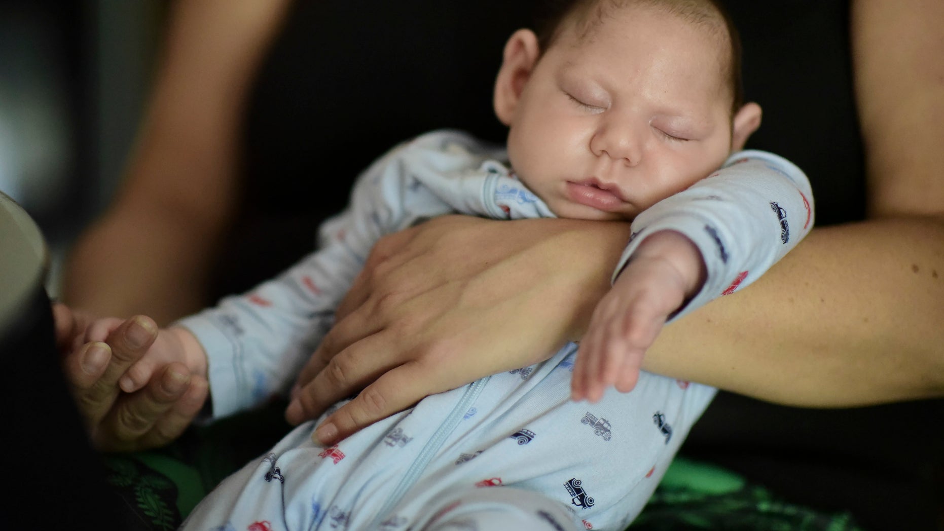 In this Dec. 16, 2016 photo, two-month-old Inti Perez, diagnosed with microcephaly linked to the mosquito-borne Zika virus, is cradled by his mother, in Bayamon, Puerto Rico. The U.S. Centers for Disease Control and Prevention has projected a surge of cases next year. (AP Photo/Carlos Giusti)