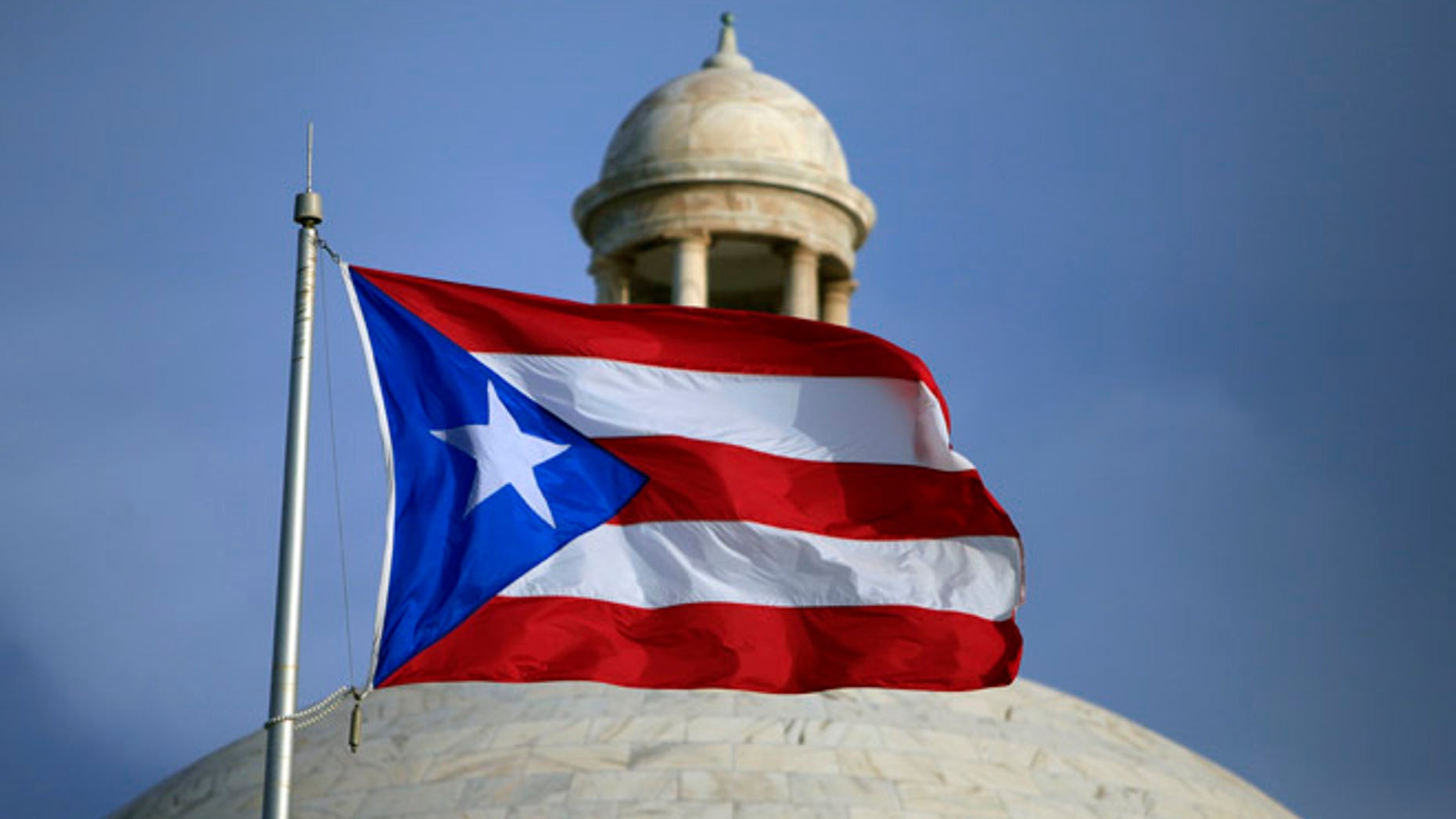 In this July 29, 2015 file photo, the Puerto Rican flag flies in San Juan.