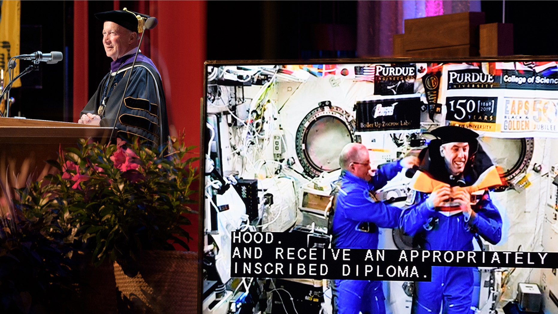 Purdue University President Mitch Daniels connects with Purdue alumni astronauts Scott Tingle, left, and Andrew Feustel, who are aboard the International Space Station some 250-plus miles above Earth.