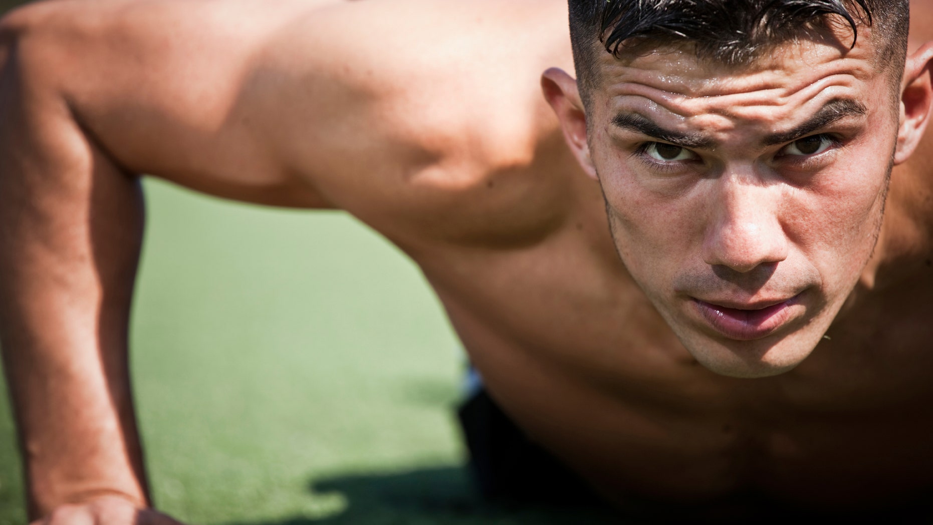 A shot of a hispanic athlete doing a push-up