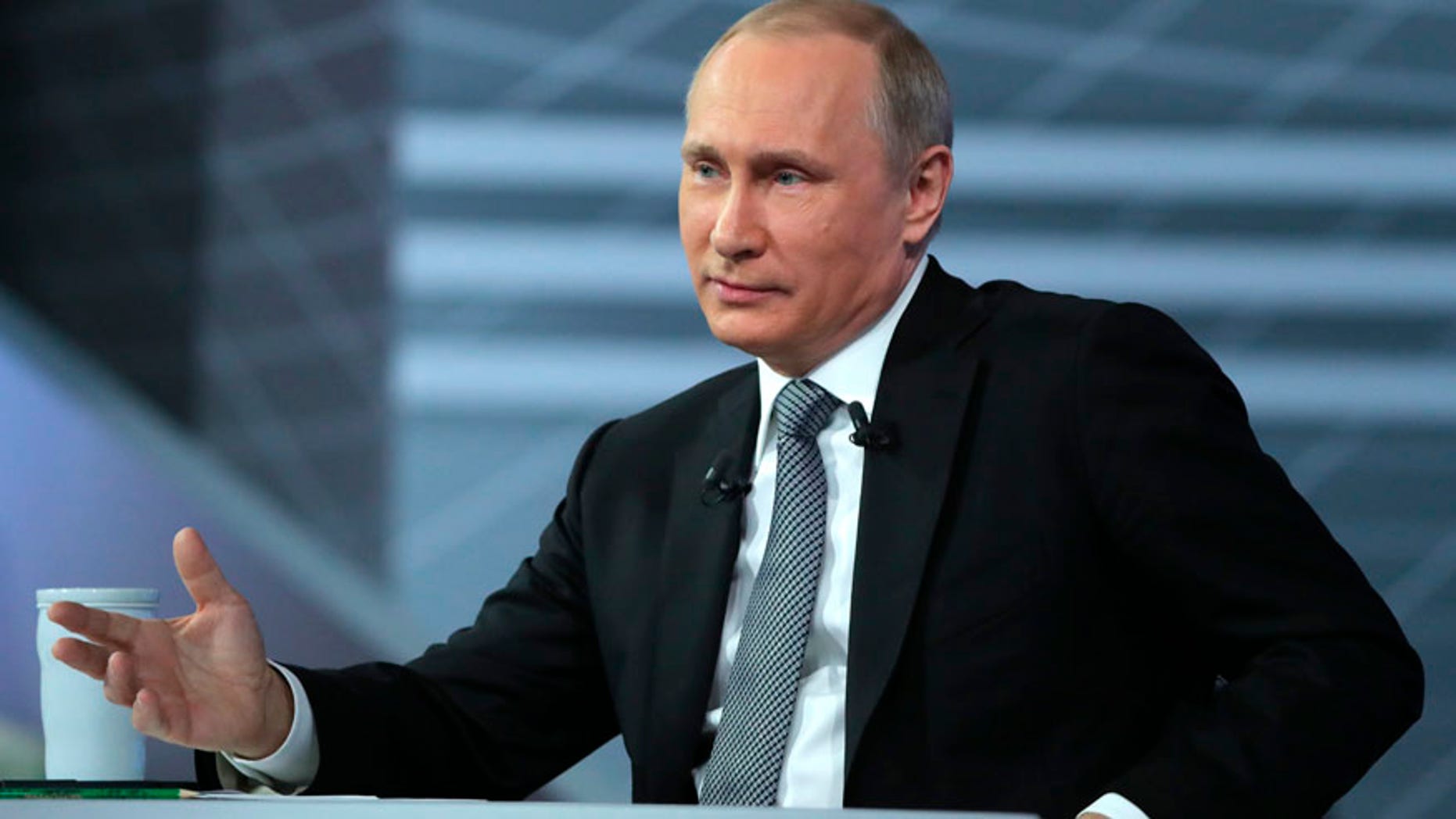 Russian President Vladimir Putin gestures while speaking during his annual call-in show in Moscow, Russia, Thursday, April 14, 2016. The Kremlin has been sifting through more than 1 million questions from across the country to get Putin ready for the television marathon. (Mikhail Klimentyev/Sputnik, Kremlin Pool Photo via AP)