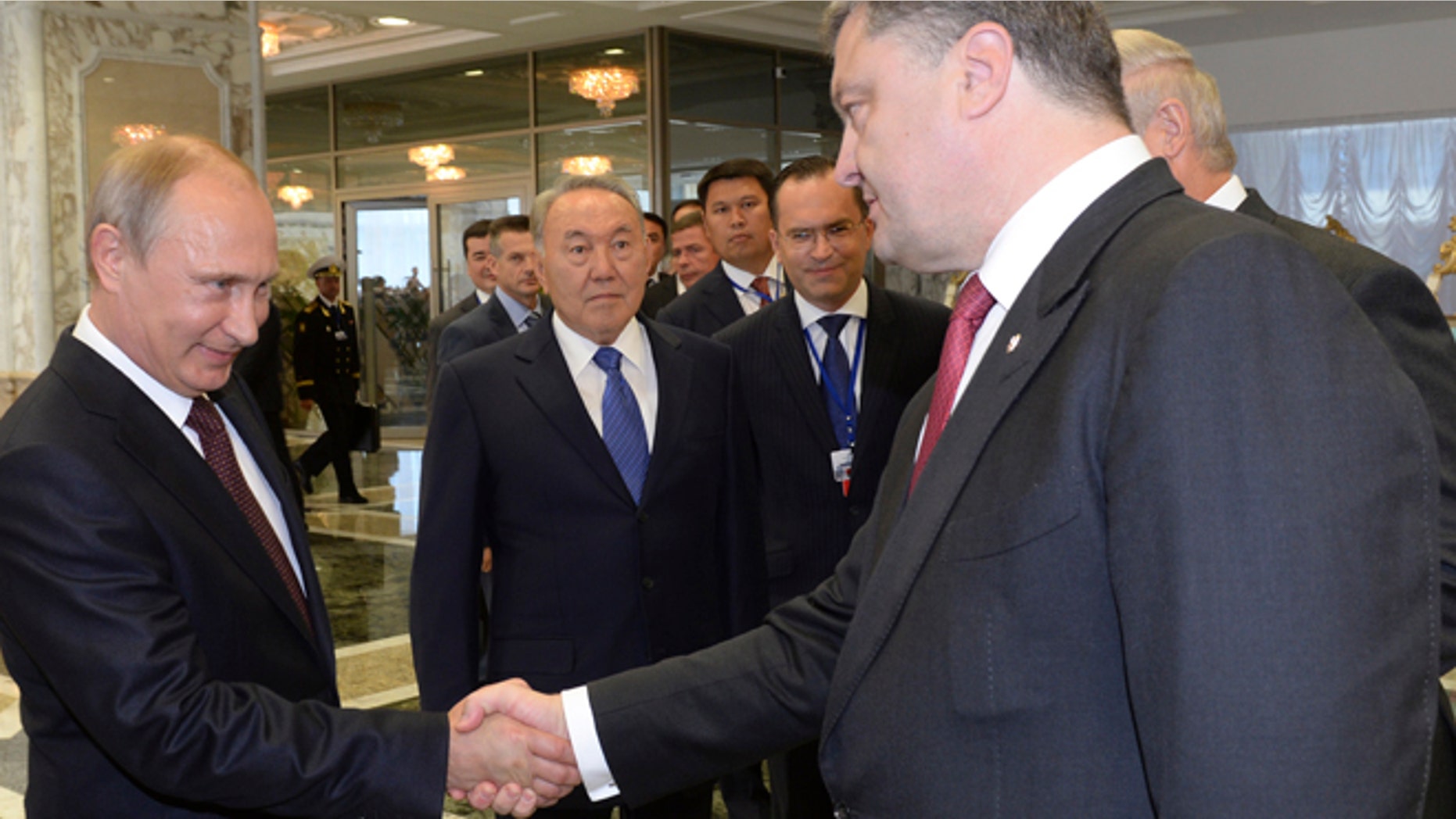 Aug. 26, 2014: Russian President Vladimir Putin, left, shakes hands with Ukrainian President Petro Poroshenko, right, as Kazakh President Nursultan Nazarbayev, center, looks at them, prior to their talks after after posing for a photo in Minsk, Belarus. Leaders of Russia, Belarus, two other former Soviet republics as well as top EU officials are meeting in Minsk, Belarus, for a highly anticipated summit to discuss the crisis in Ukraine which has left more than 2,000 dead and displaced over 300,000 people.
