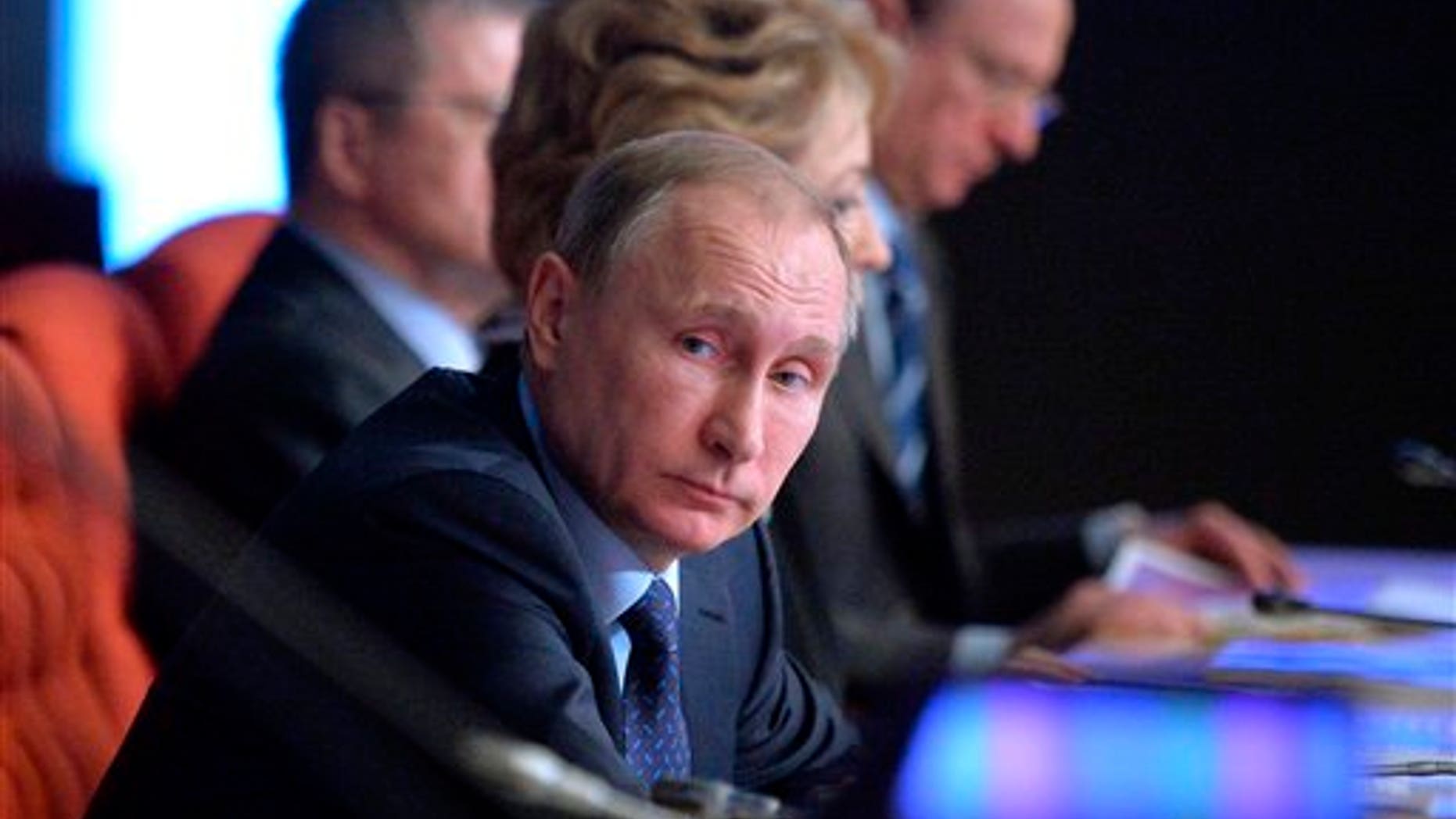 Russian President Vladimir Putin, foreground, listens during a meeting of Russian judges in Moscow, Russia, Tuesday, Feb. 16, 2016. (Alexei Druzhinin/Sputnik, Kremlin Pool Photo via AP)