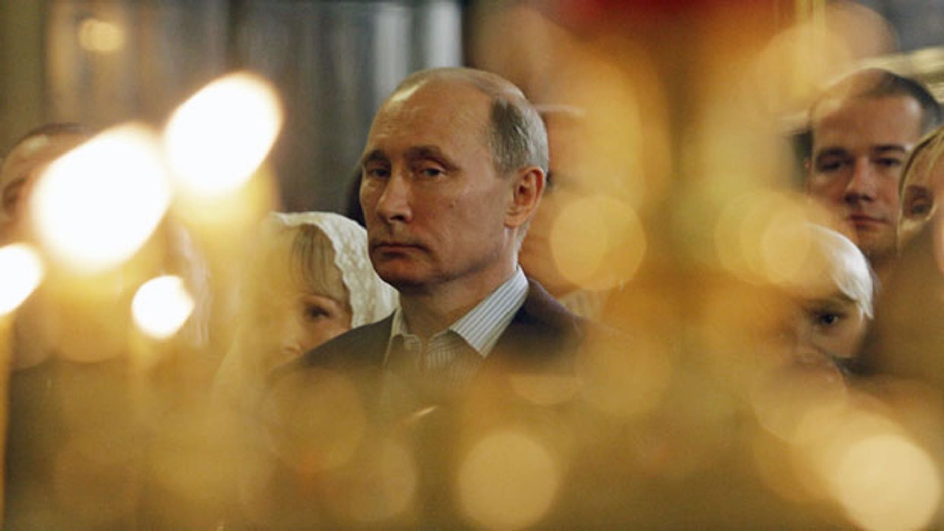 Vladimir Putin attends a Russian Orthodox Christmas service in 2012. (AP)