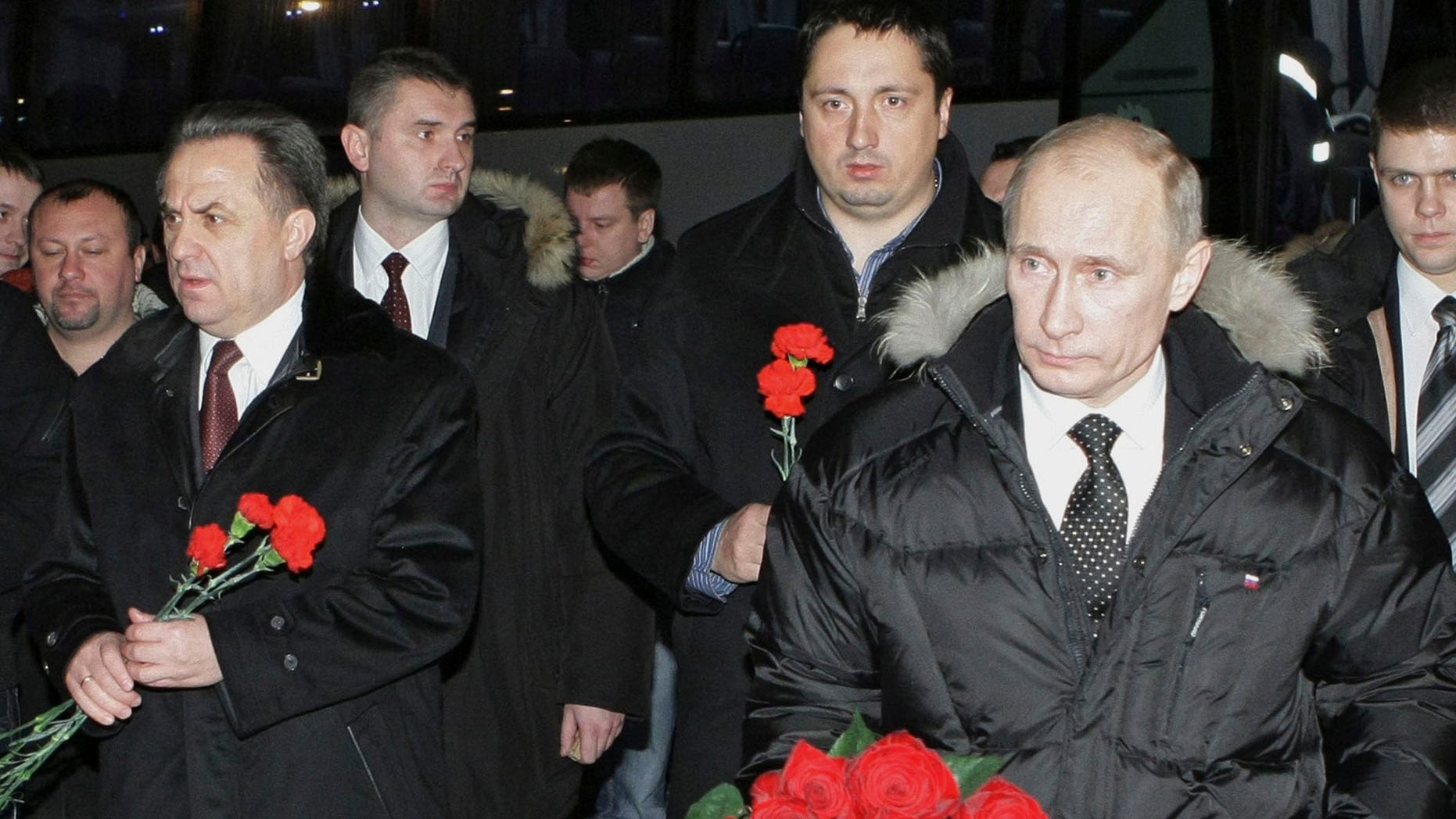 Dec. 21: Russian Prime Minister Vladimir Putin, Sports Minister Vitaly Mutko and the head of the soccer fans association Alexander Shprygin walk to lay flowers at the grave of a soccer fan Yegor Sviridov, 28, who was killed on Dec. 6 in an attack on soccer supporters, Moscow, Russia.