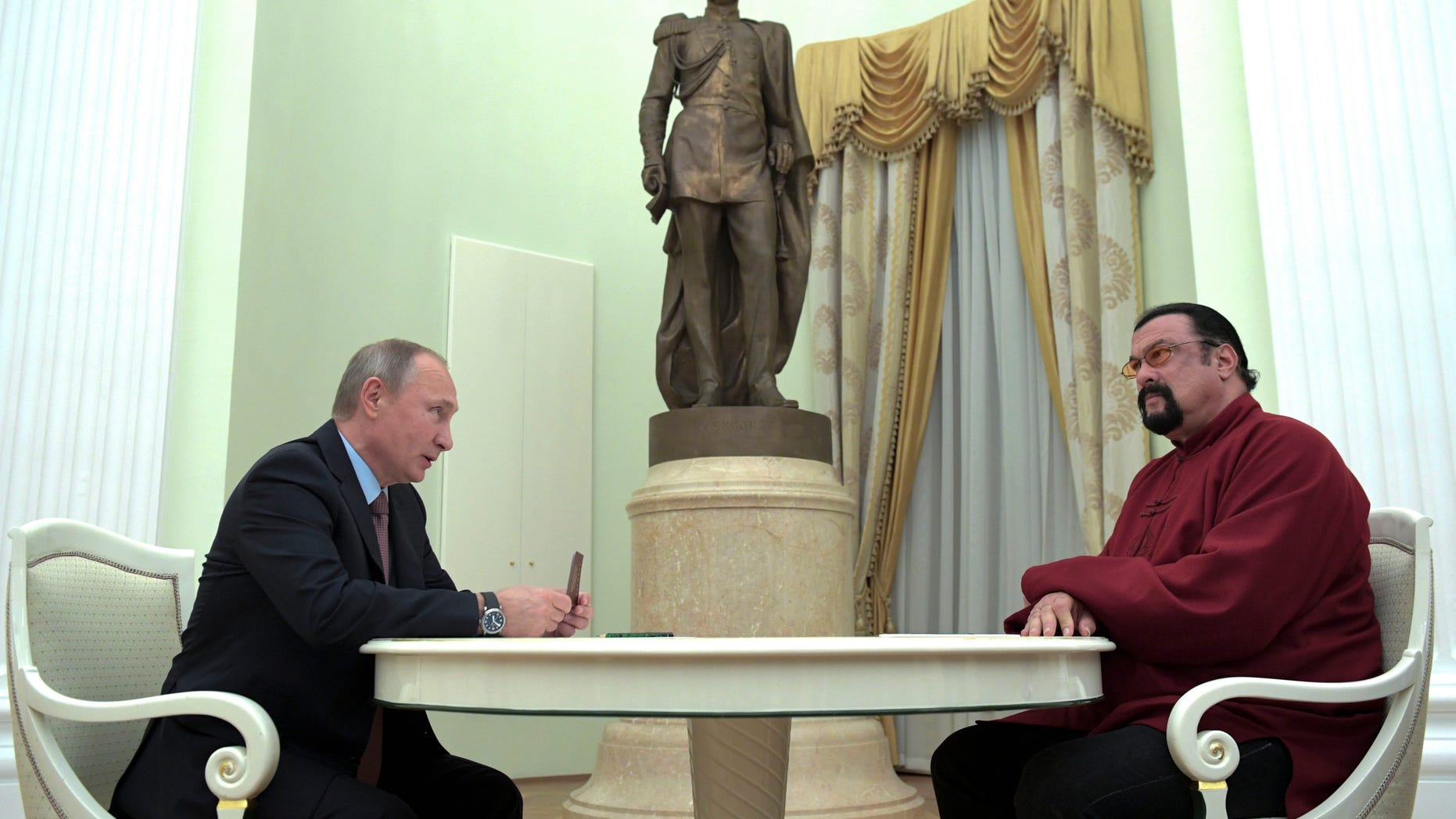 Russian President Vladimir Putin, left, hosts U.S. actor Steven Seagal in the Kremlin in Moscow, Friday, Nov. 25, 2016. Putin has given a Russian passport to Seagal, a regular visitor to Russia in recent years, calling it a sign of a thaw in relations between the two countries. (Alexei Druzhinin/Sputnik, Kremlin Pool Photo via AP)