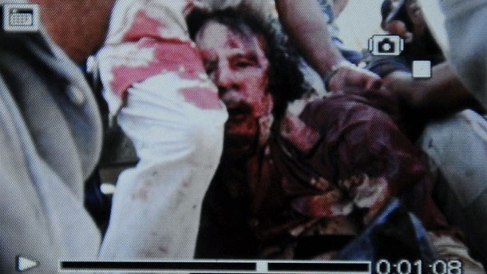 An image captured by AFP from a cell phone purportedly shows a wounded or dead Muammar Qaddafi.