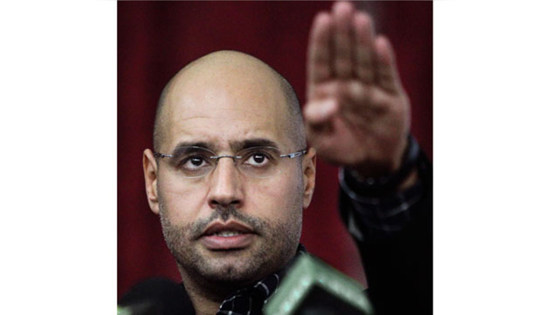 March 10, 2011: Seif al-Islam Qaddafi, son of Libyan leader Muammar Qaddafi, gestures as he speaks to supporters and the media in Tripoli, Libya.