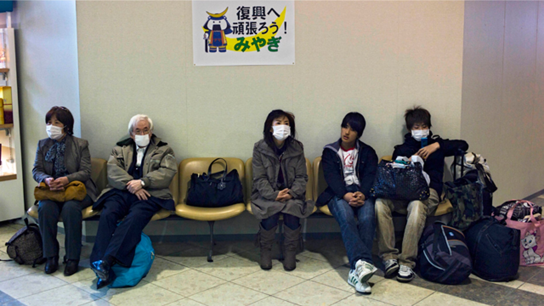 April 13: Passengers wait for departure in Sendai airport in Natori city, near Sendai, Miyagi Prefecture, Japan. Commercial flights to this coastal city resumed partially Wednesday, just over a month after a 32-foot tsunami scoured the airport's runways. (AP)