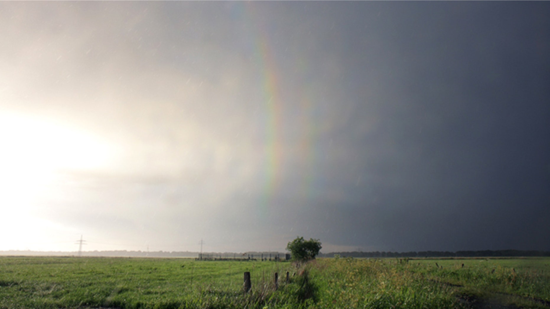 The first picture ever of a quadruple rainbow shows the third-order (left) and fourth-order rainbows (right) -- the first two aren't included in the image.